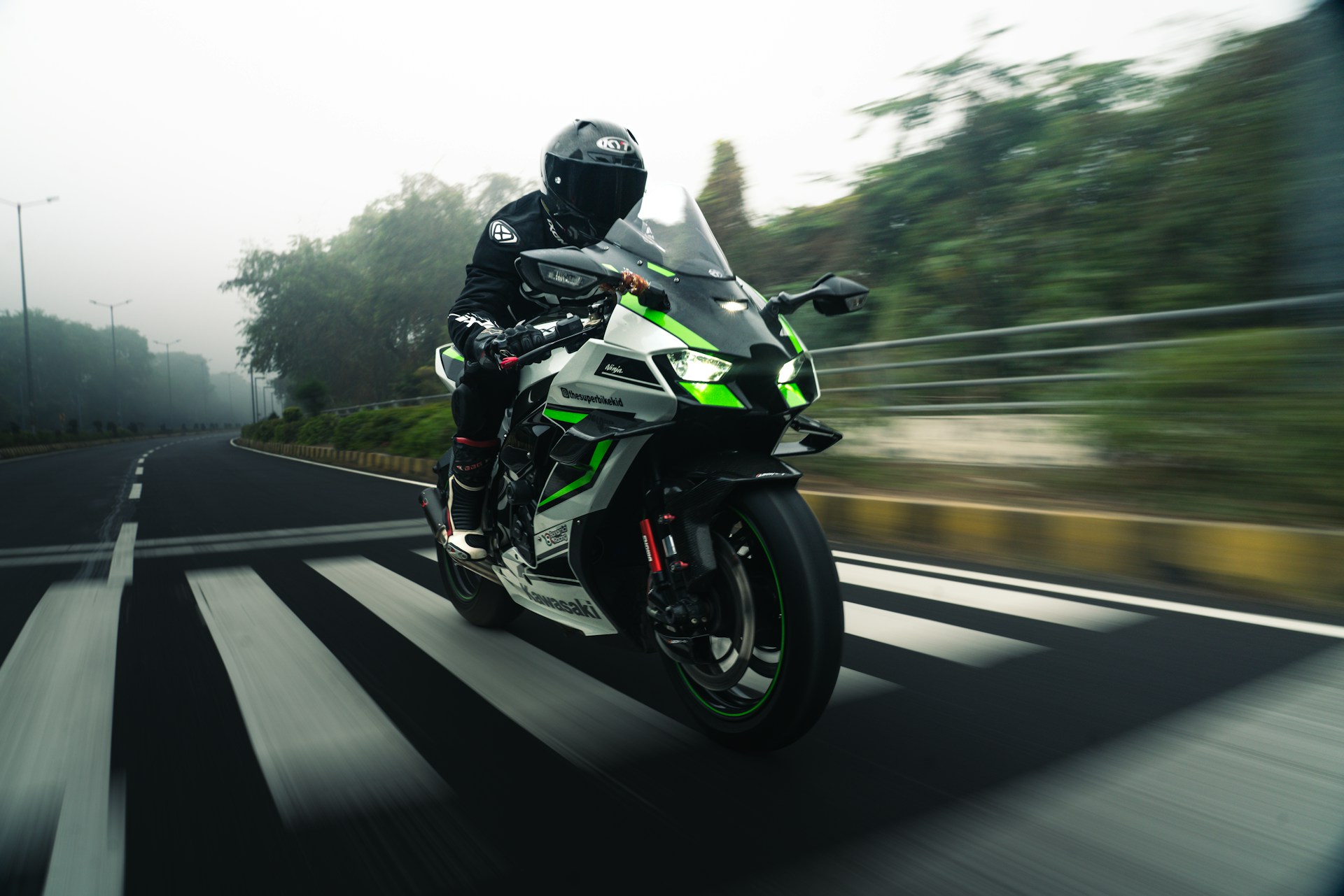 Rider on a sport motorcycle on a foggy road.