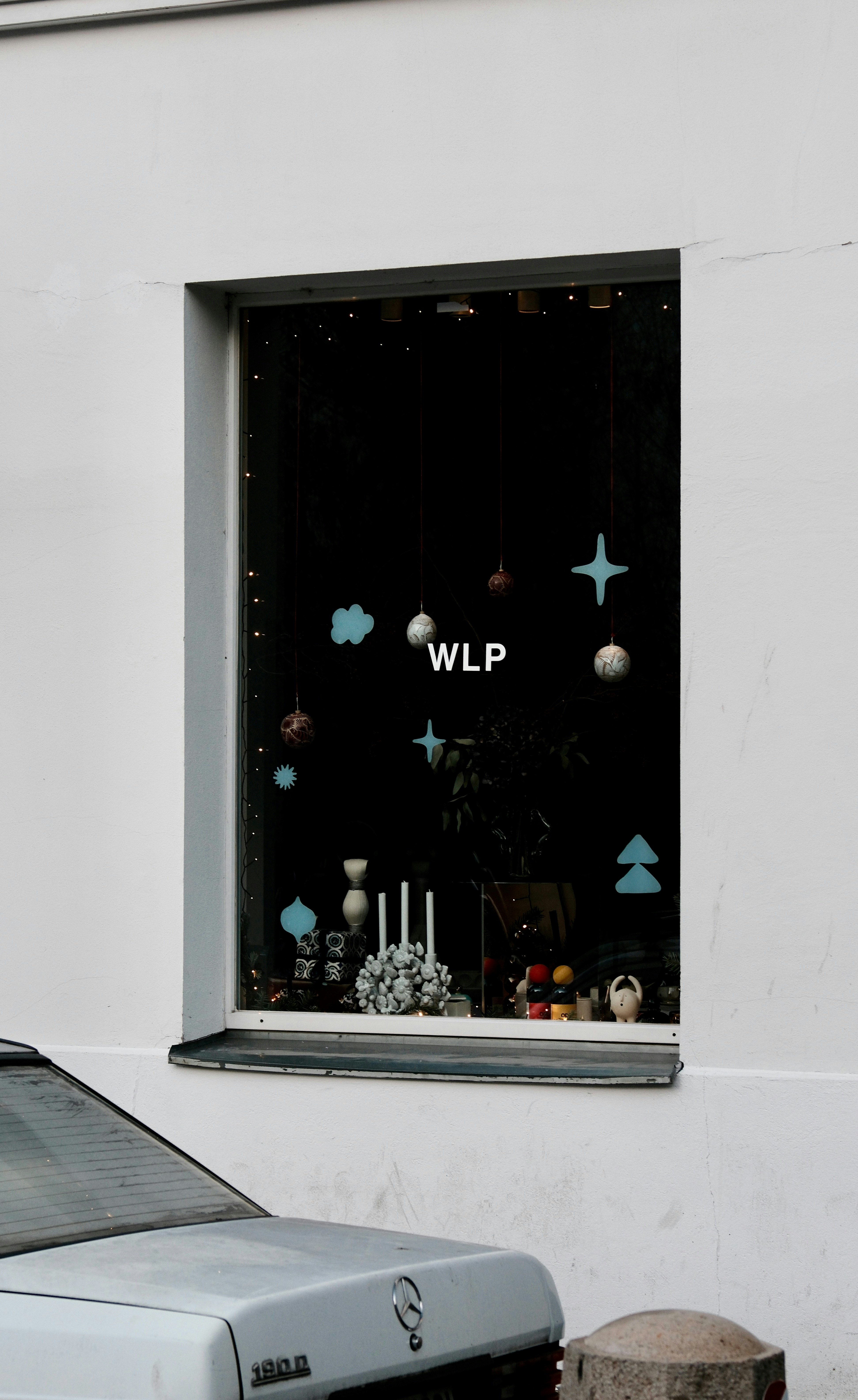 Window display with festive decorations and the letters wlp.