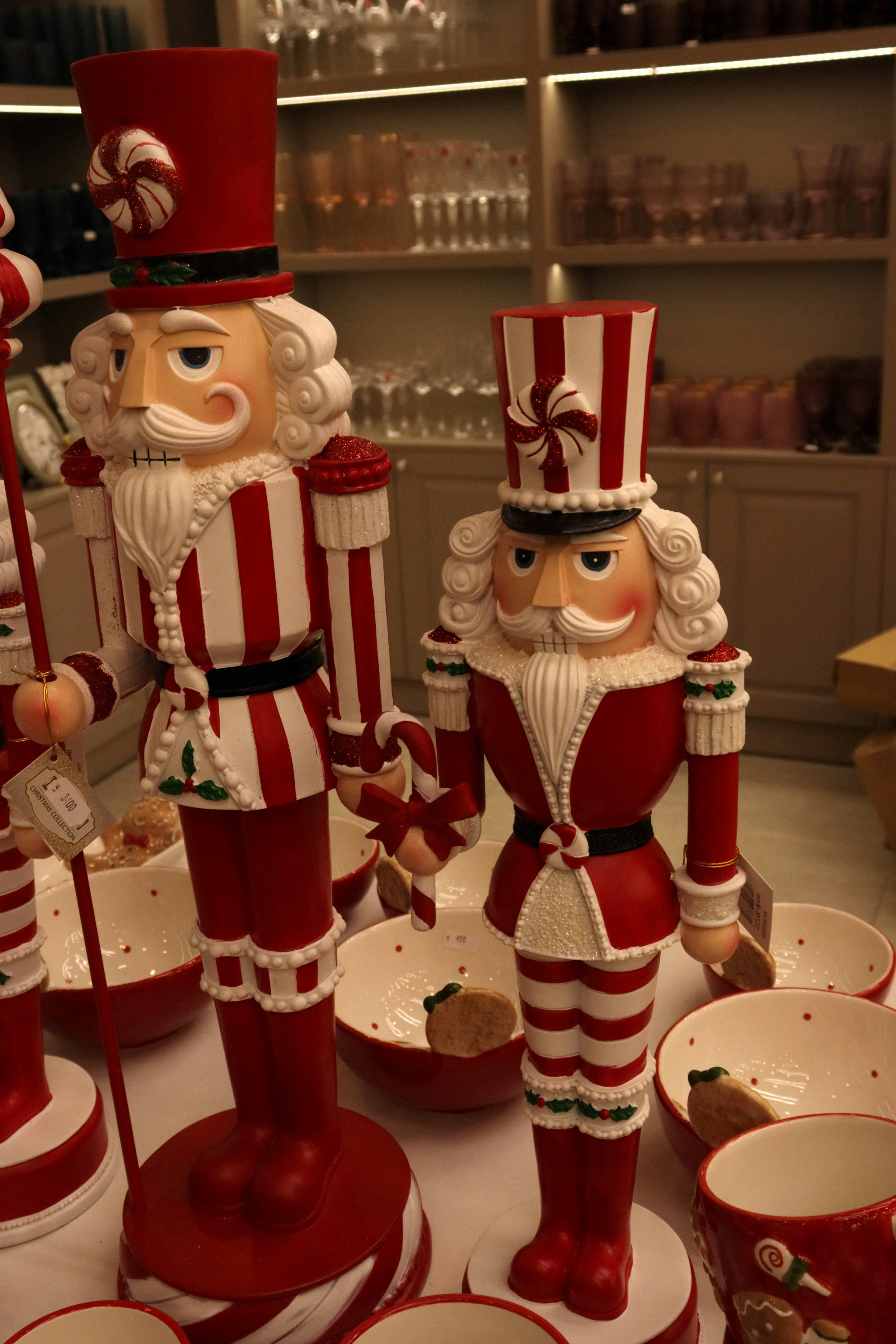 Two festive nutcracker figures in red and white.