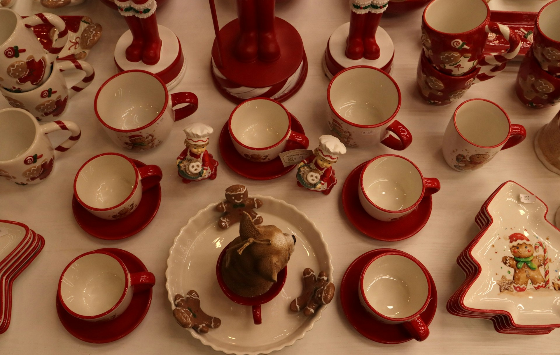Red and white christmas themed mugs and dishes.
