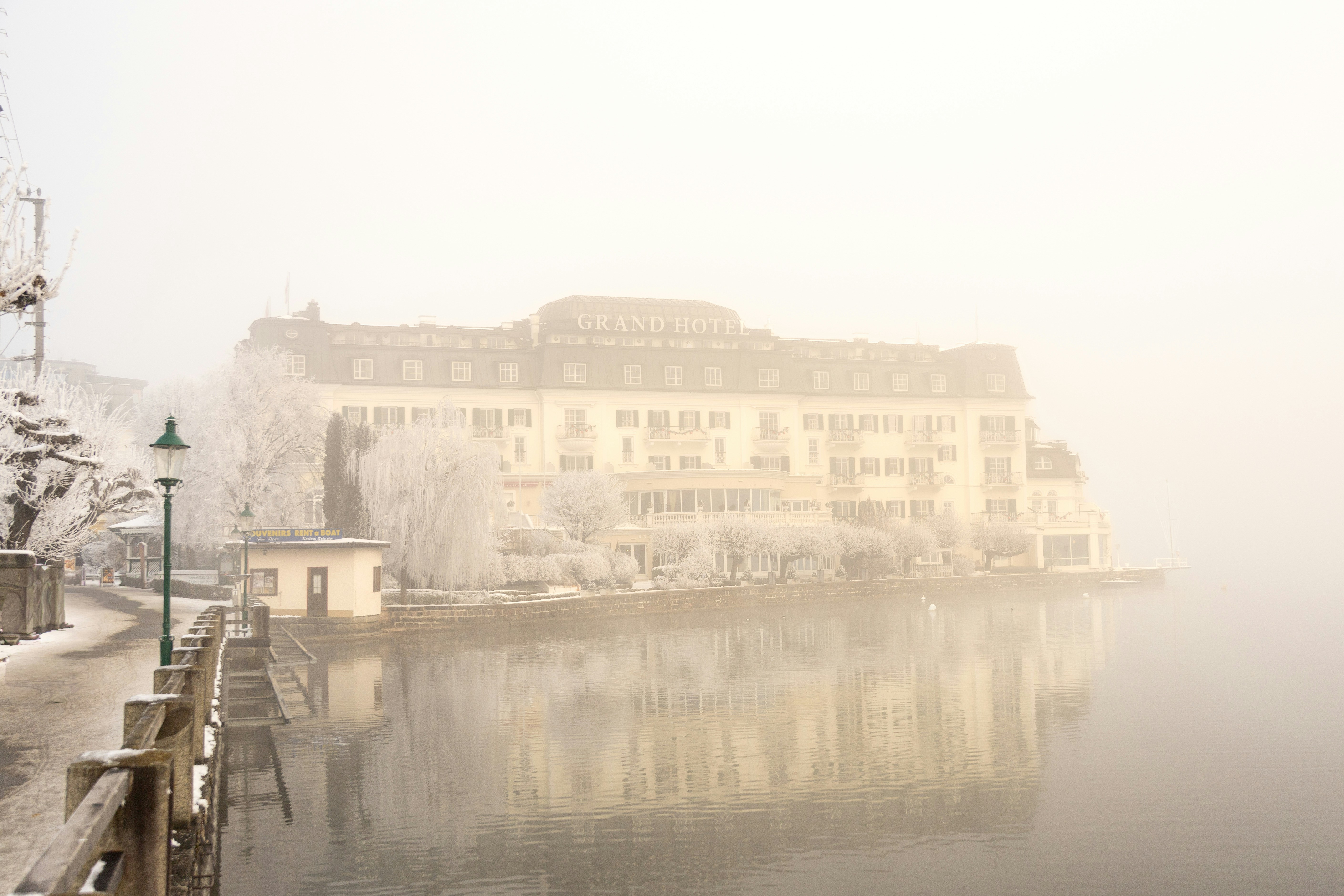 Construyendo sobre un lago con niebla y árboles nevados.