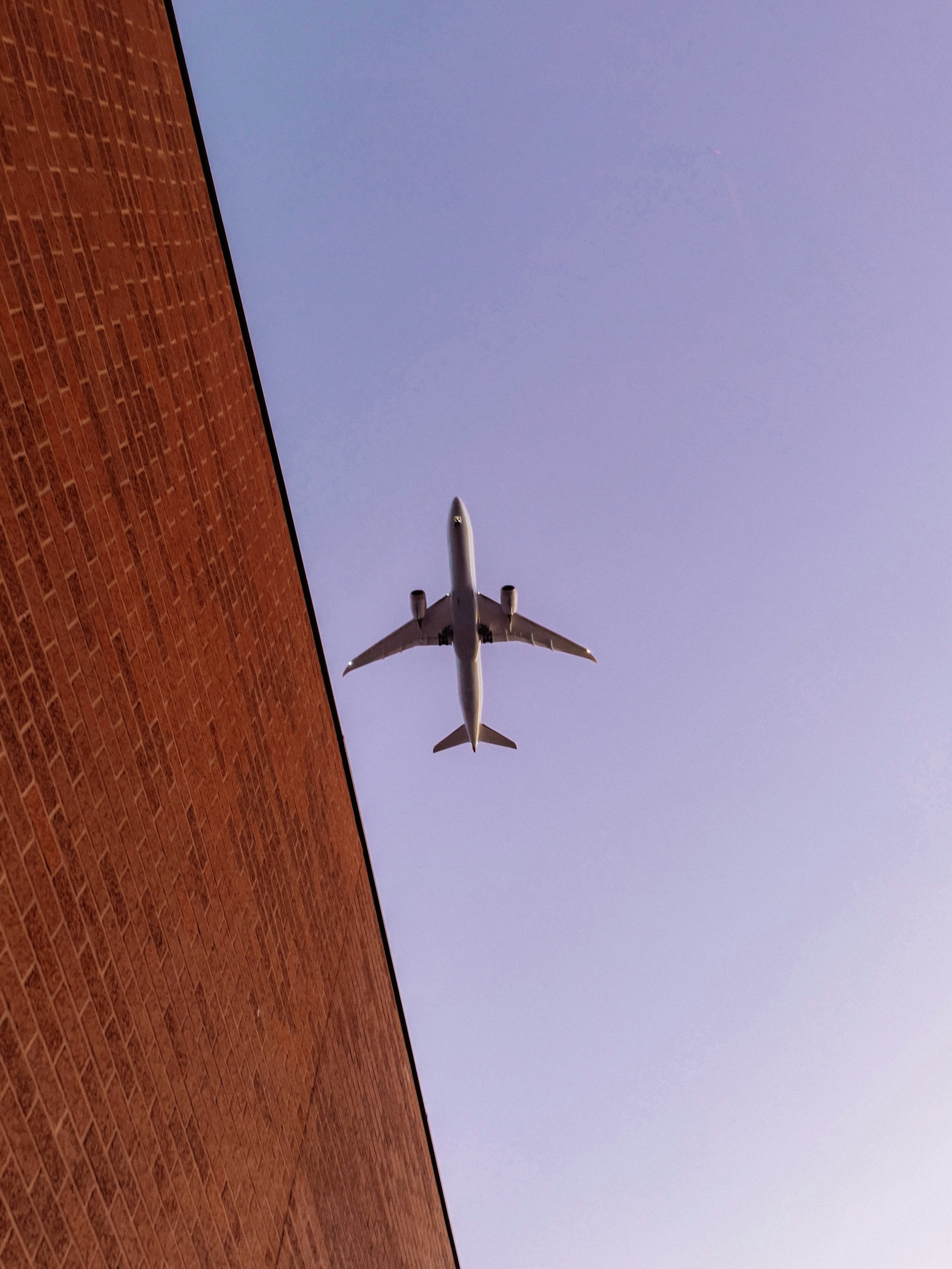 Airplane flying in the sky above a building
