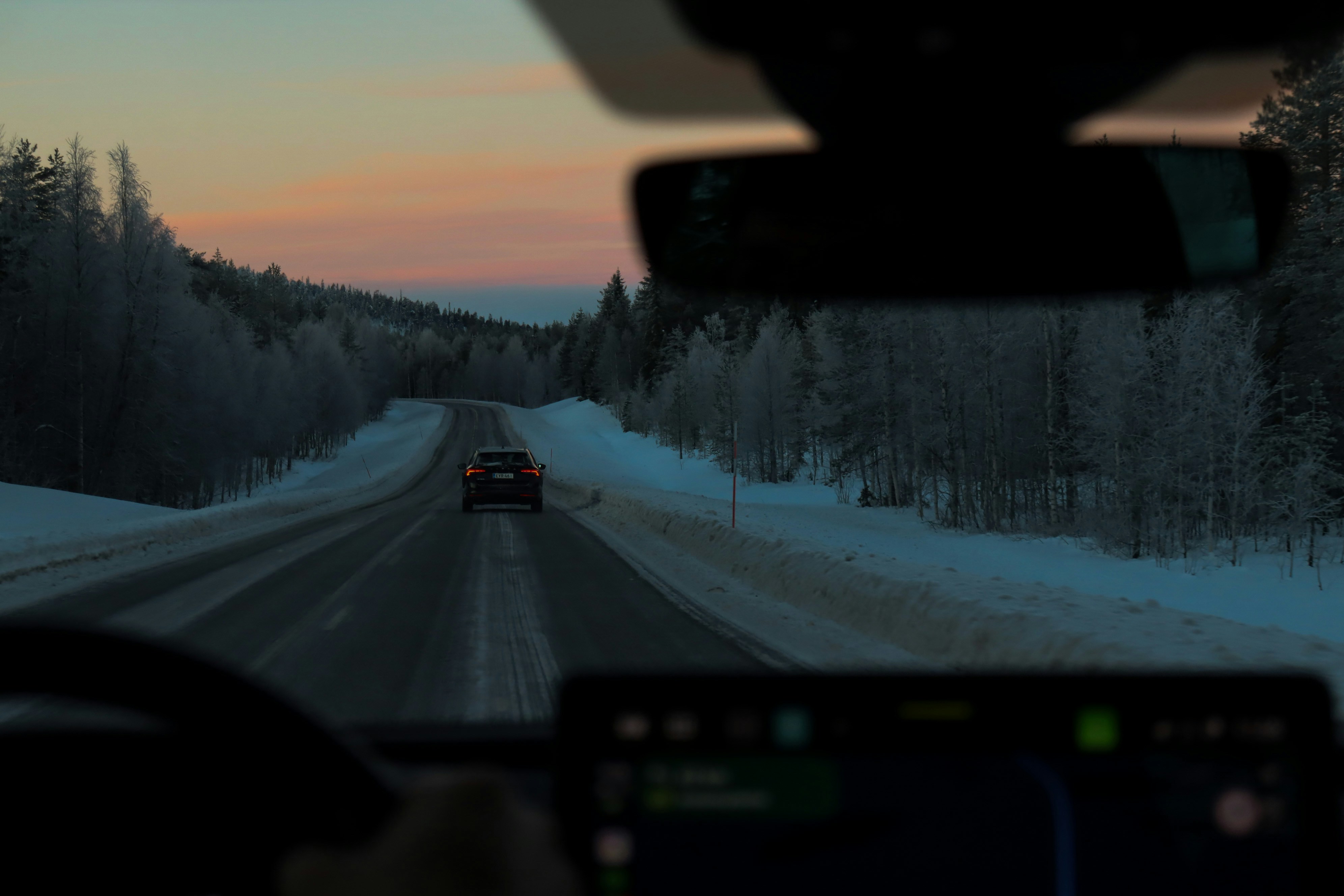 Driving on a snowy road at dusk