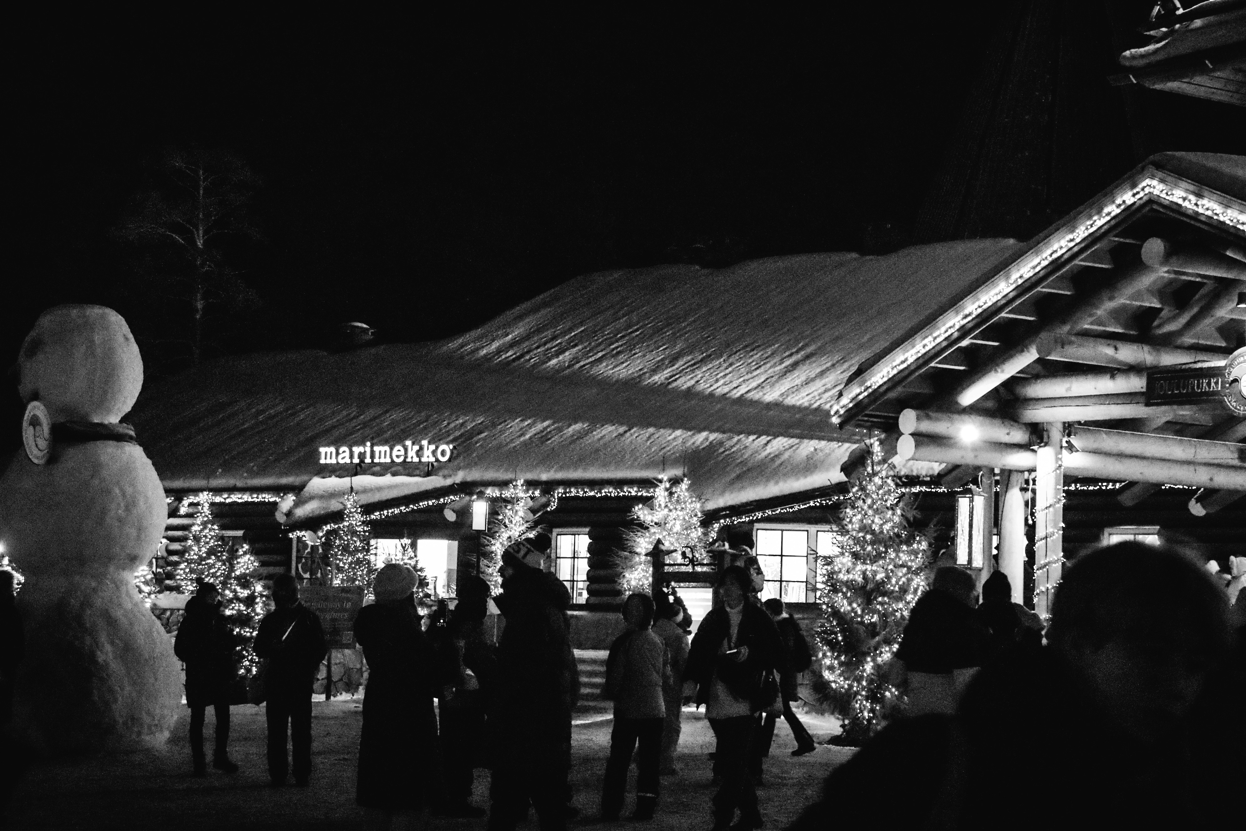 People gathered outside a building at night
