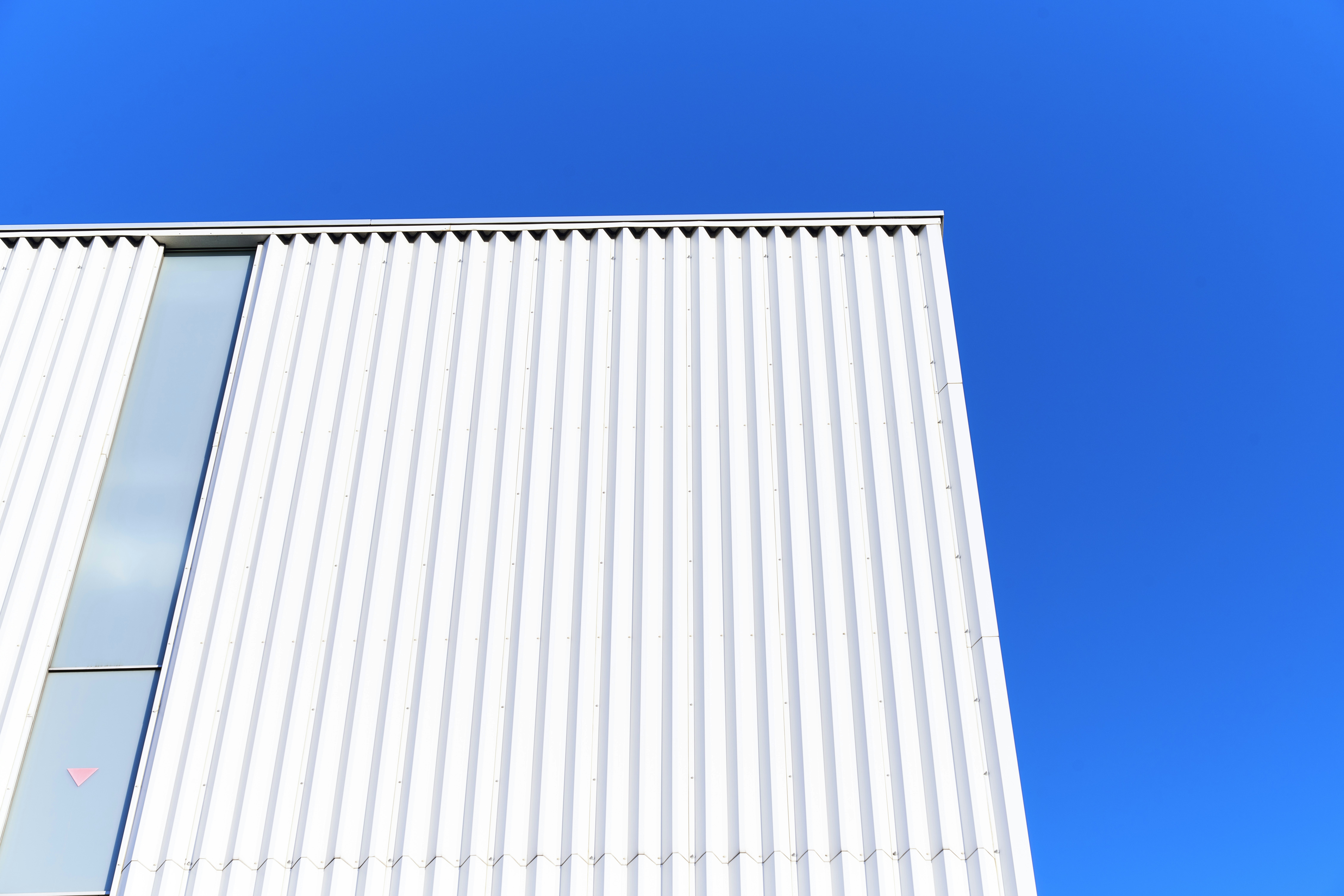 Modern white building against a clear blue sky