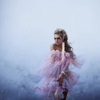 Woman in flowing pink dress with floral accents