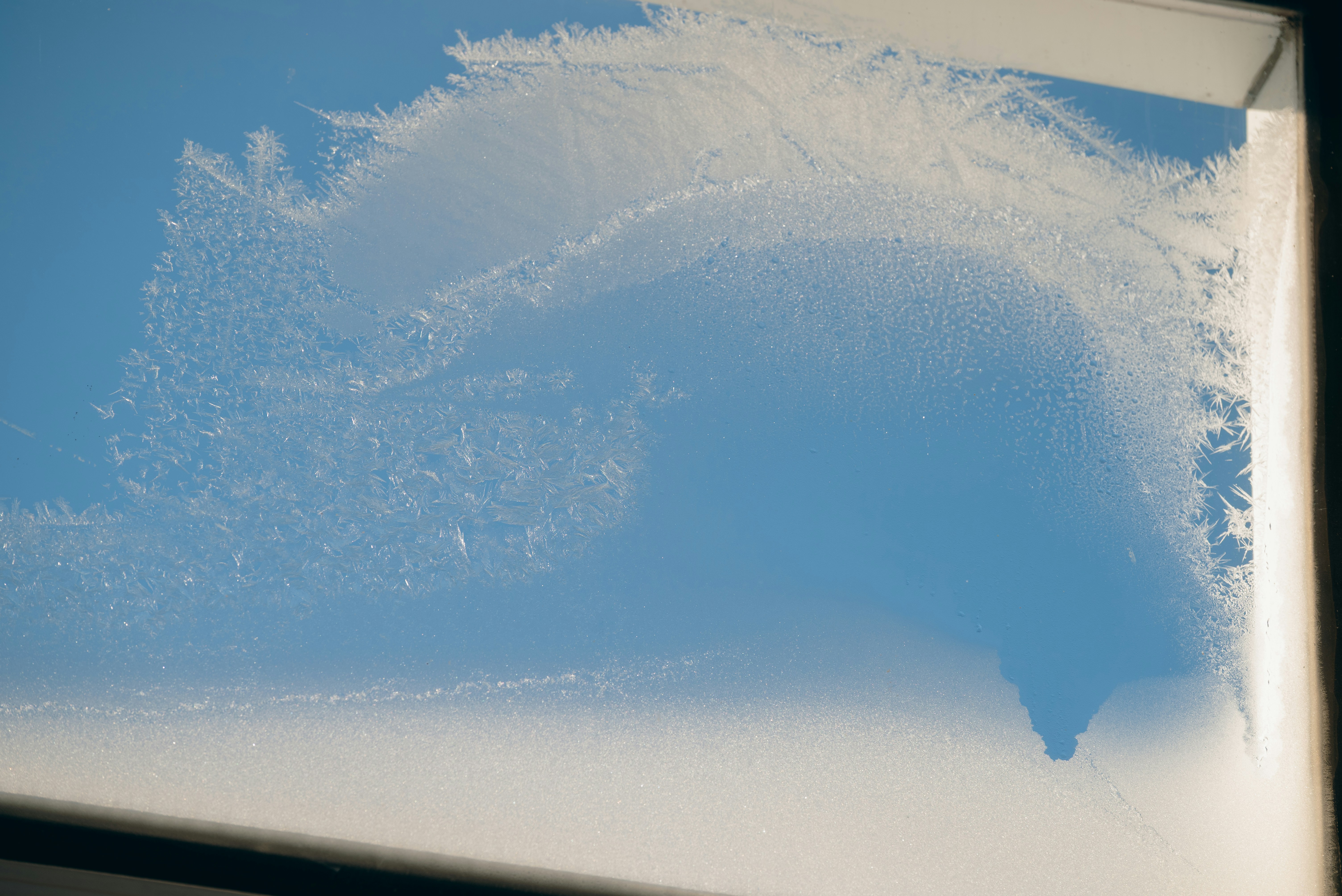 White frost patterns on a blue sky