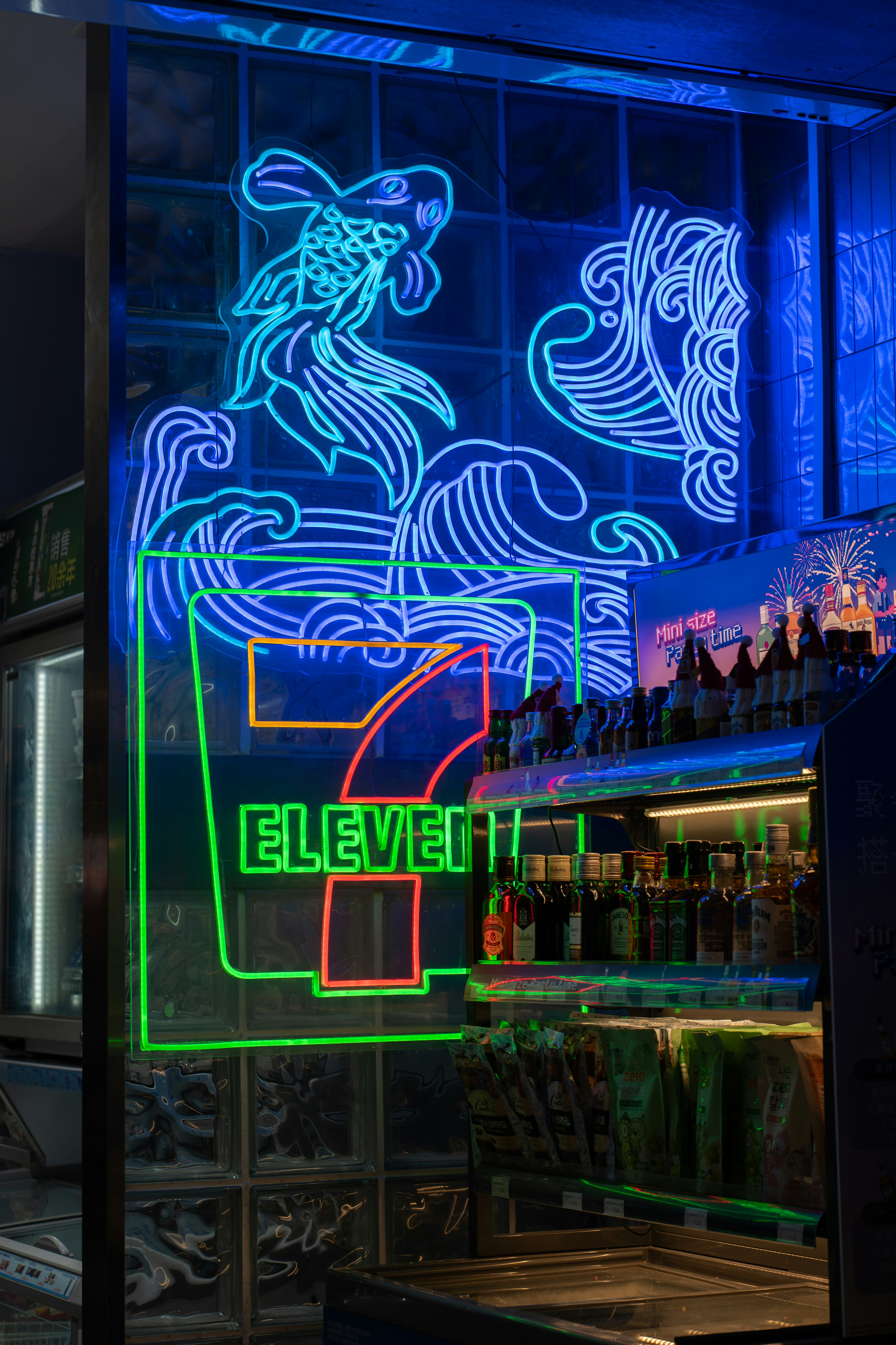 Neon fish and waves above seven eleven sign