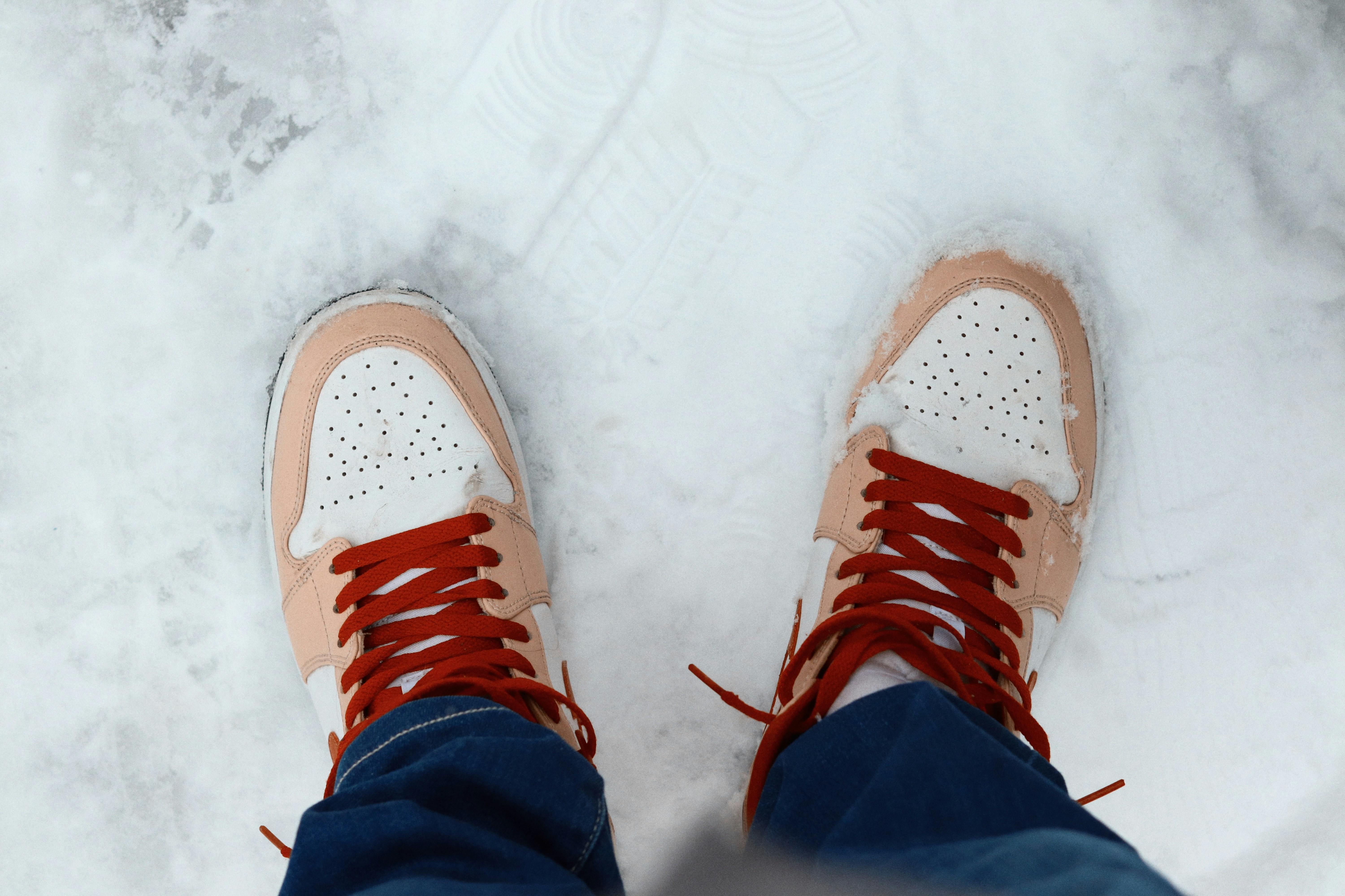 Pair of sneakers standing on snow