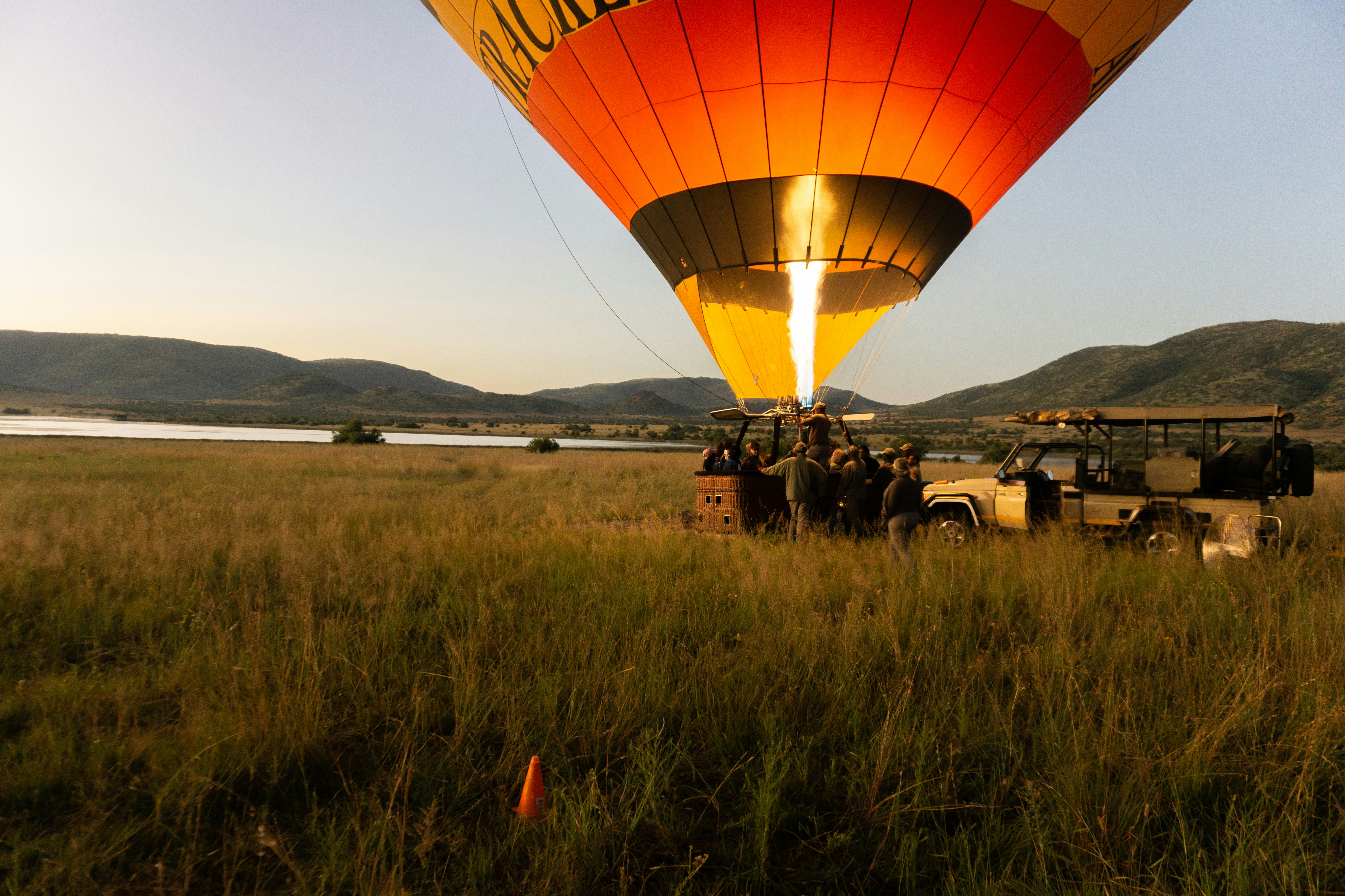 Heißluftballon wird auf einer Graswiese aufgeblasen
