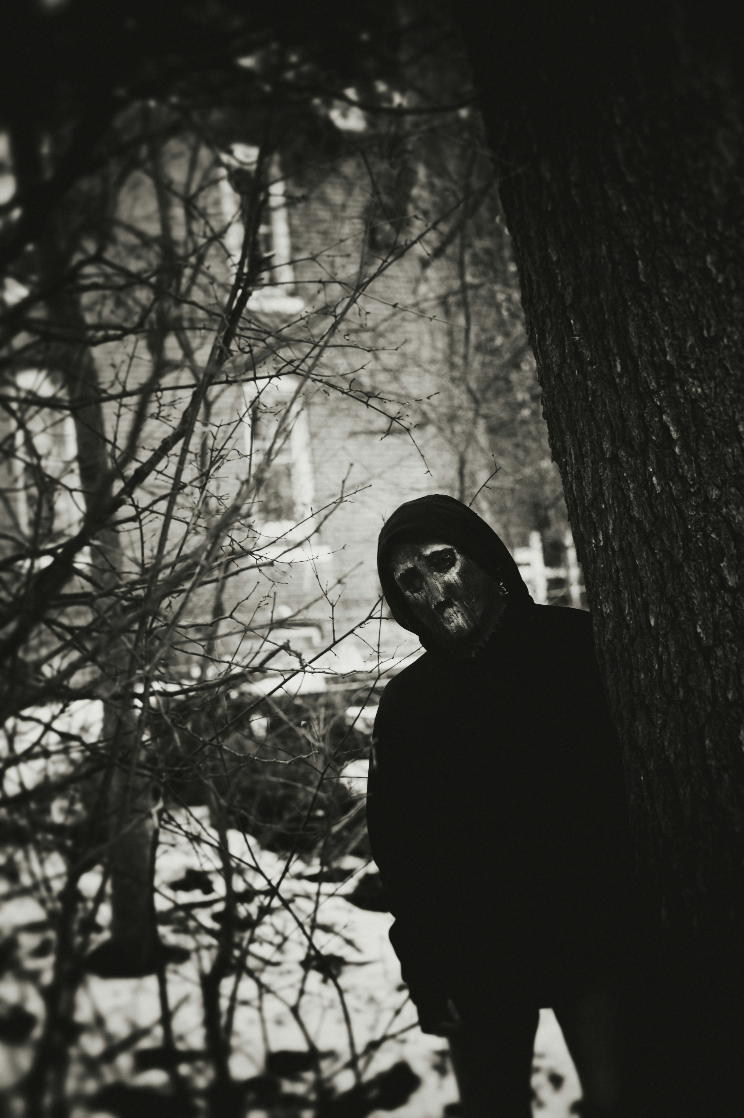 Person in creepy mask in snowy woods