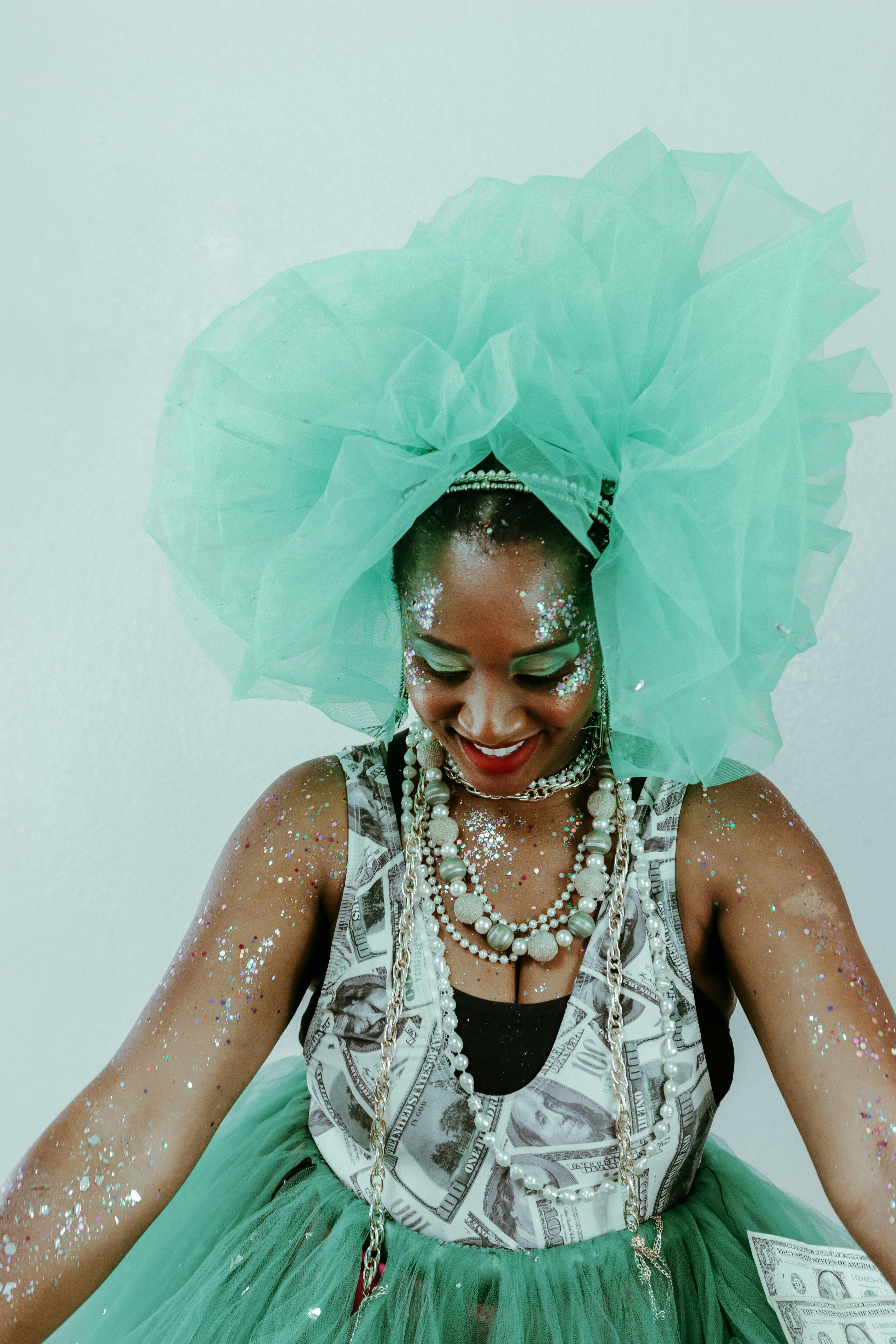 Woman in elaborate costume with glitter and pearl necklaces