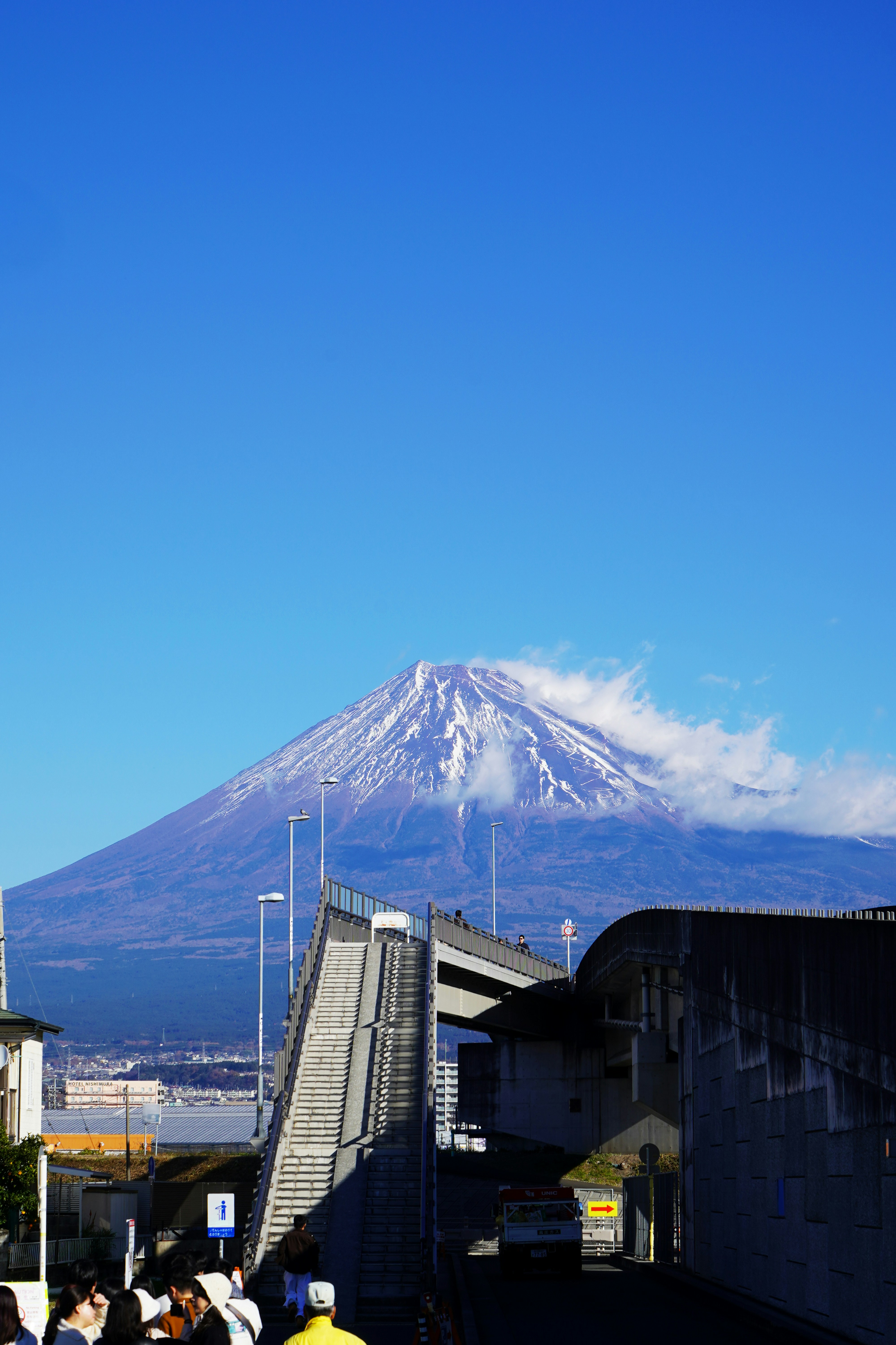 Mount fuji with snow-capped peak under blue sky.