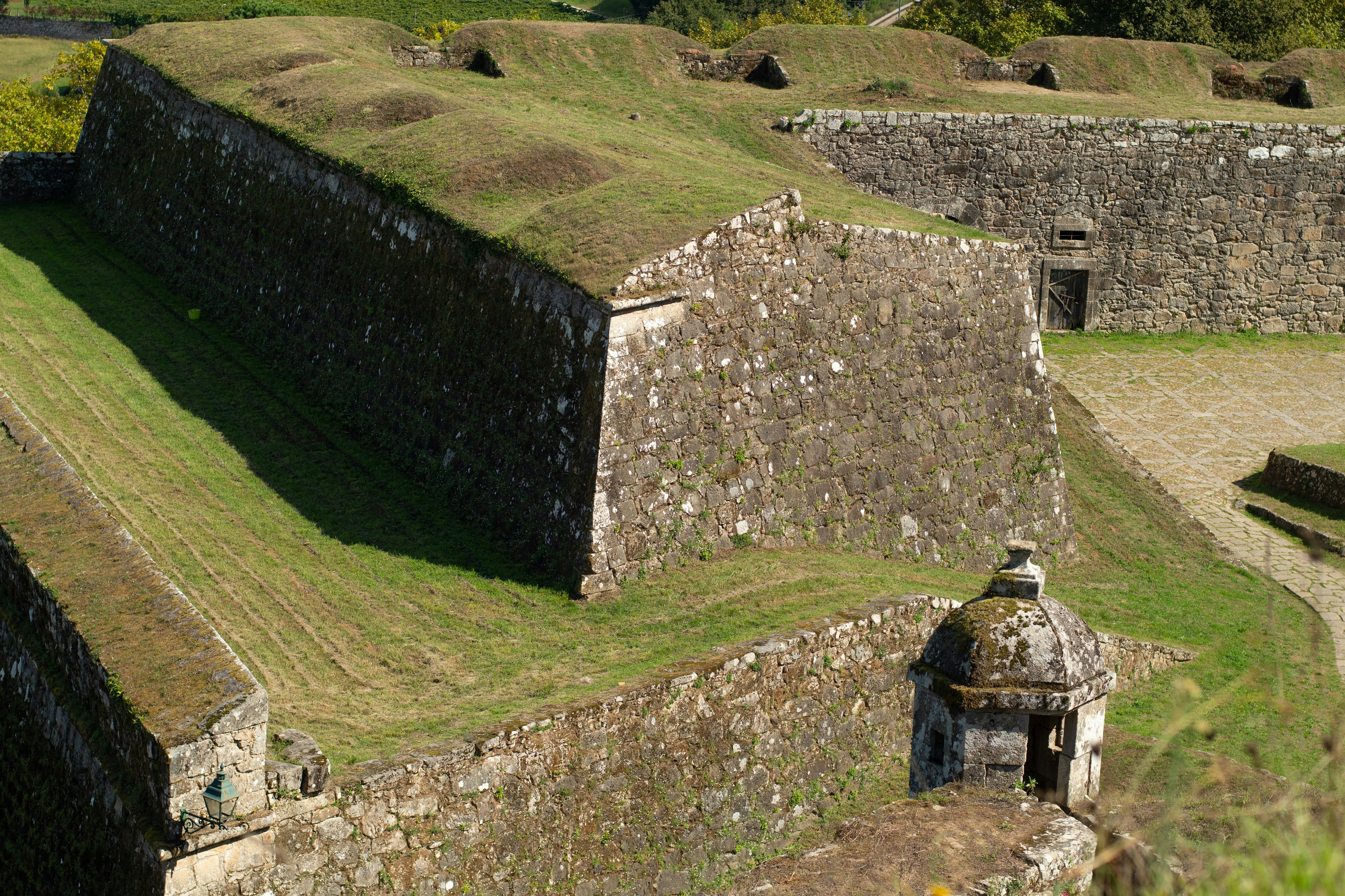 Stone fortress walls covered in green grass