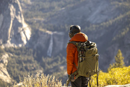 Hiker with backpack overlooking a mountain valley