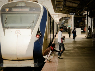 People boarding a modern train at a station.