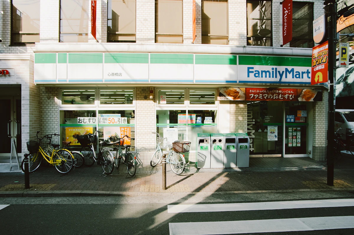 FamilyMart convenience store exterior in Namba, Osaka, Japan — the bright facade of a typical Japanese konbini