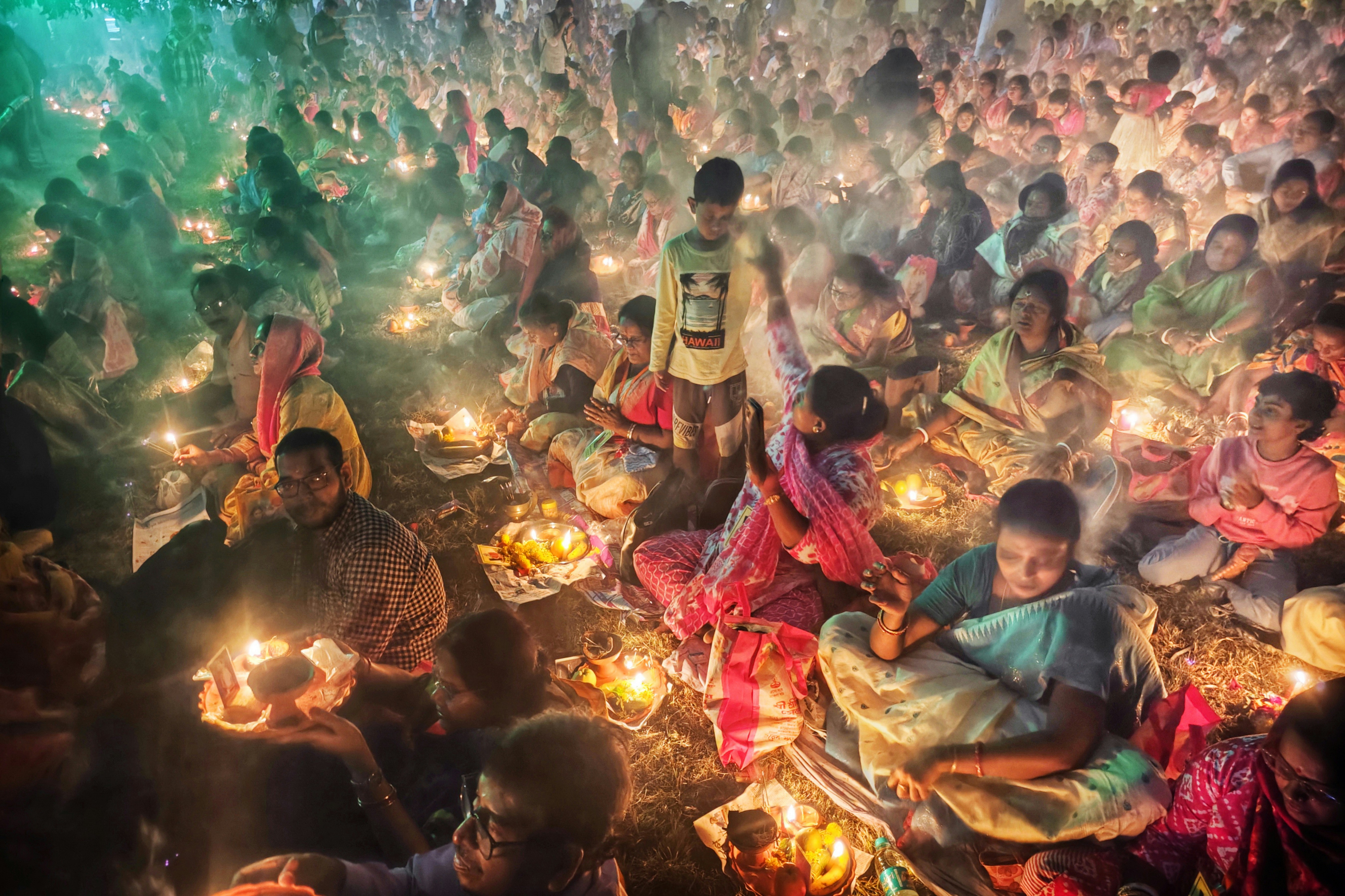 Crowd of people holding candles at night