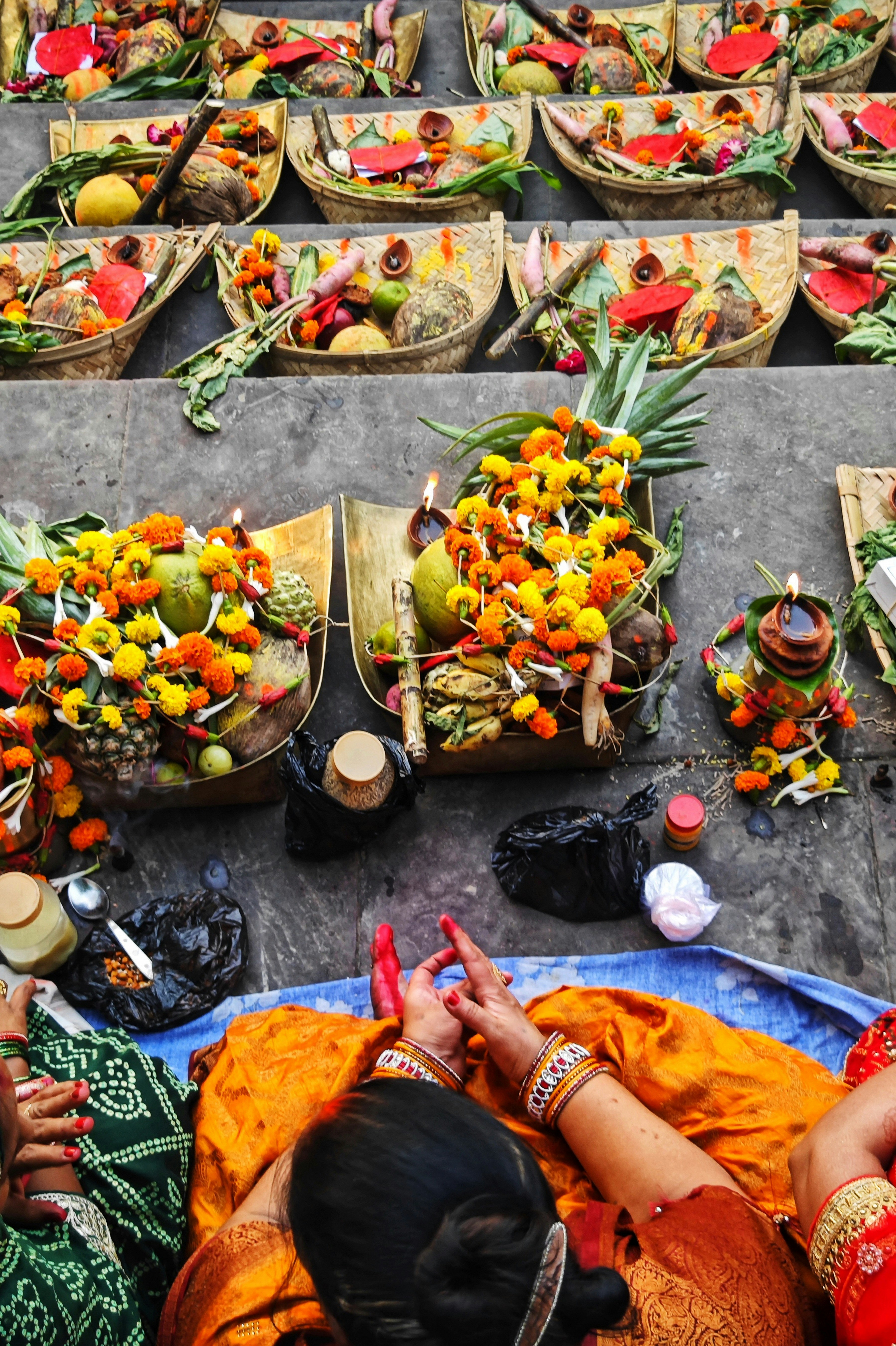 Offerings of fruits and flowers arranged in baskets.