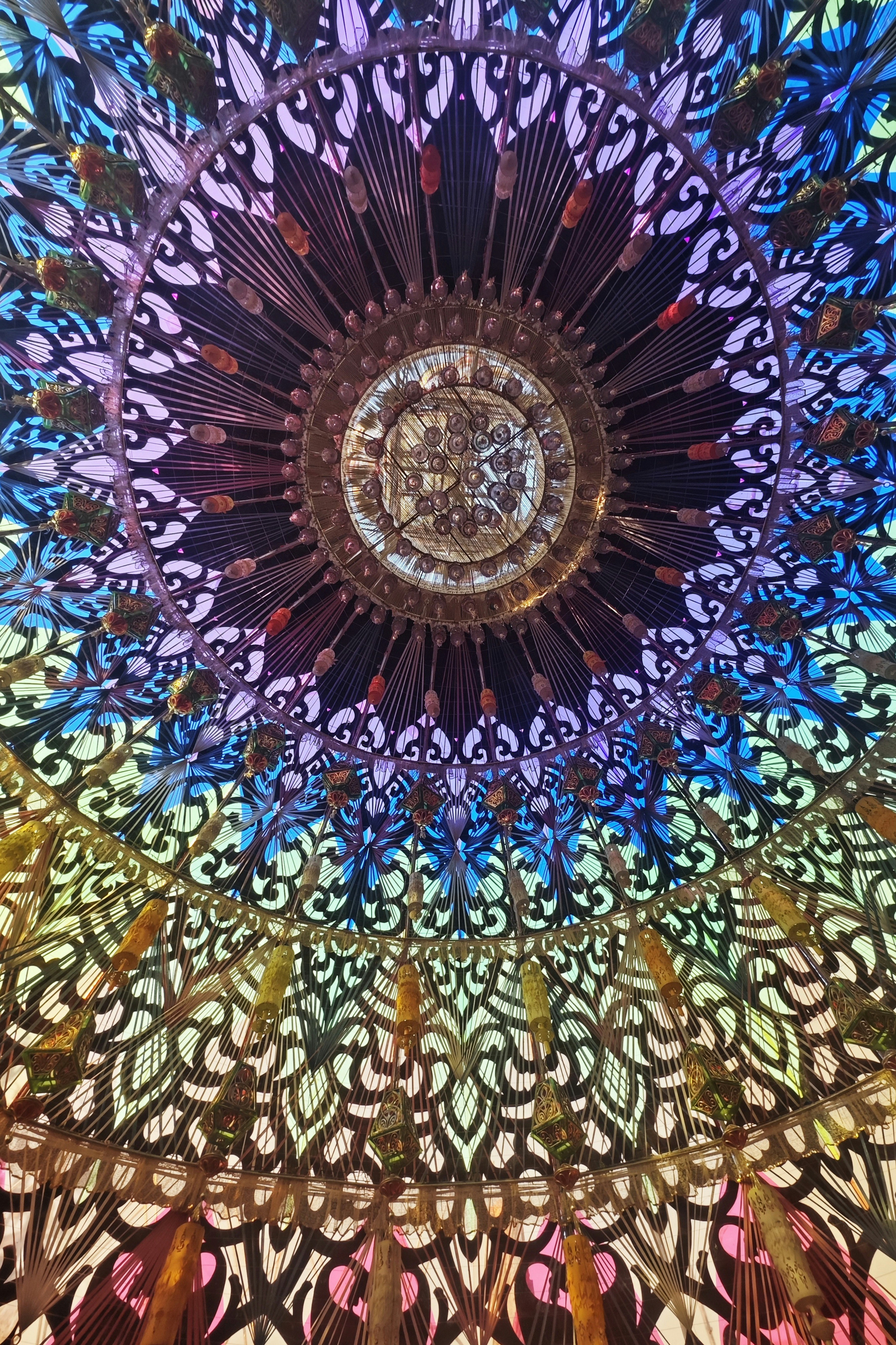 Intricate colorful mandala pattern with metallic accents.