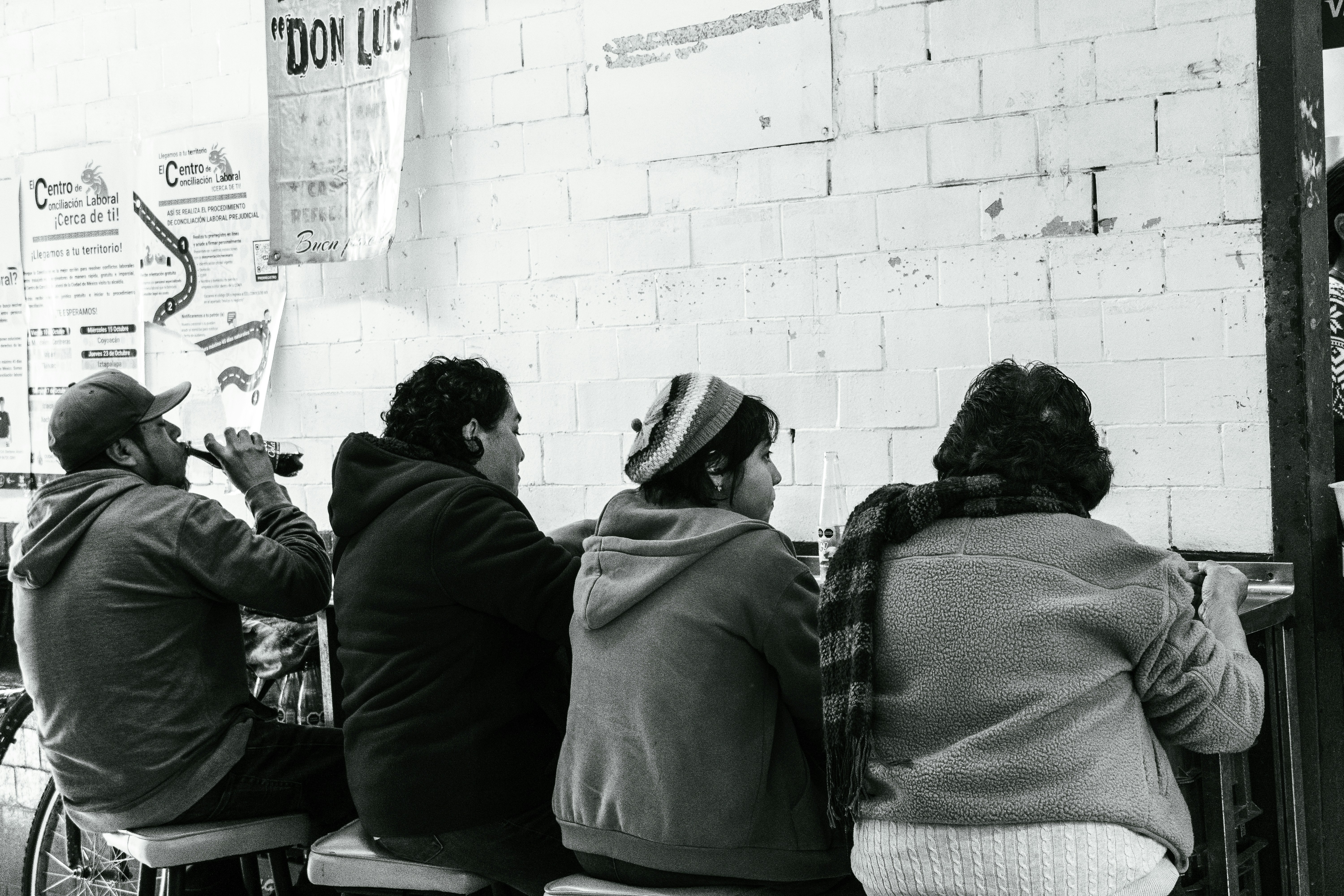Four people sitting at a counter