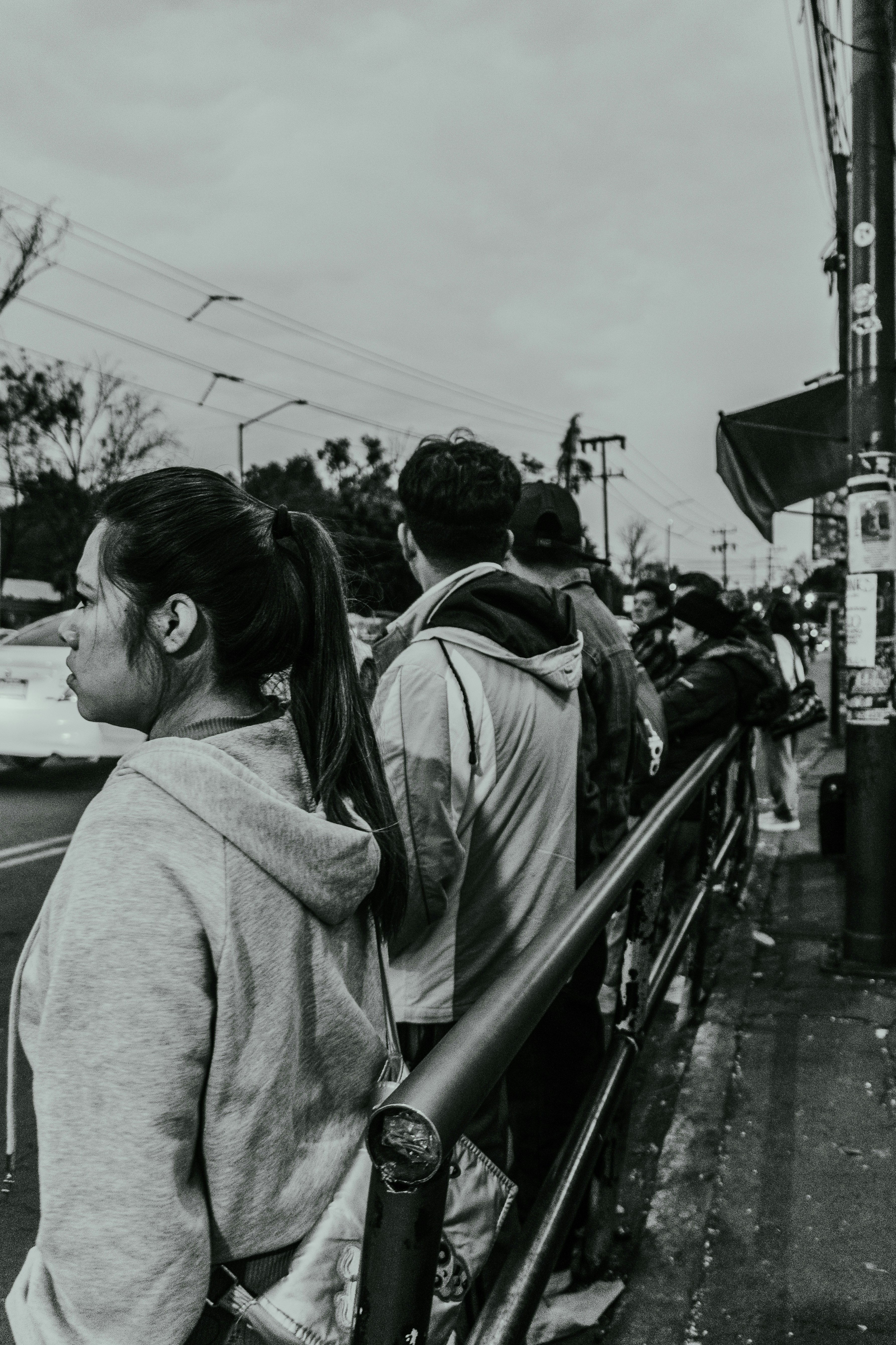 People standing in line on a city street.