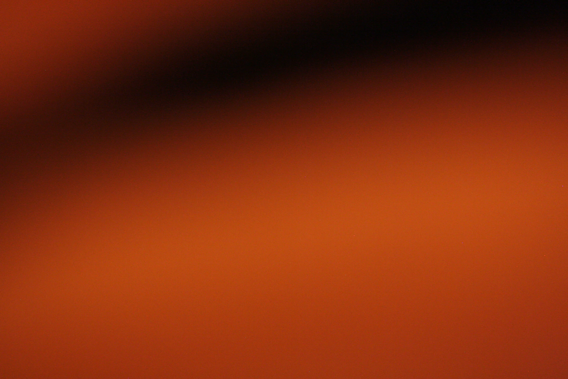 A gradient of dark brown to bright orange