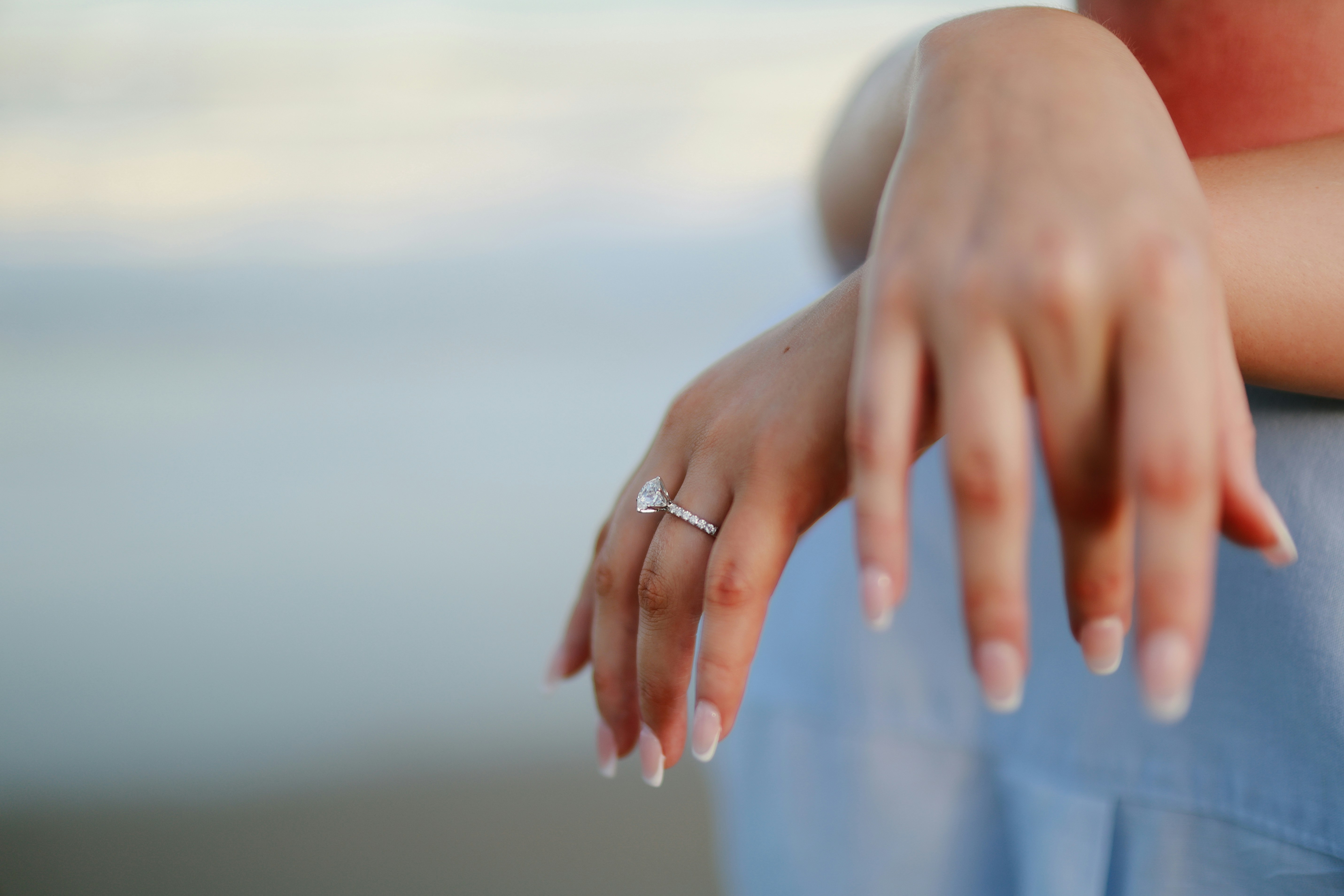 Close-up of a woman's hand with engagement ring.
