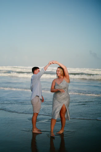 Couple dancing on a beach at sunset