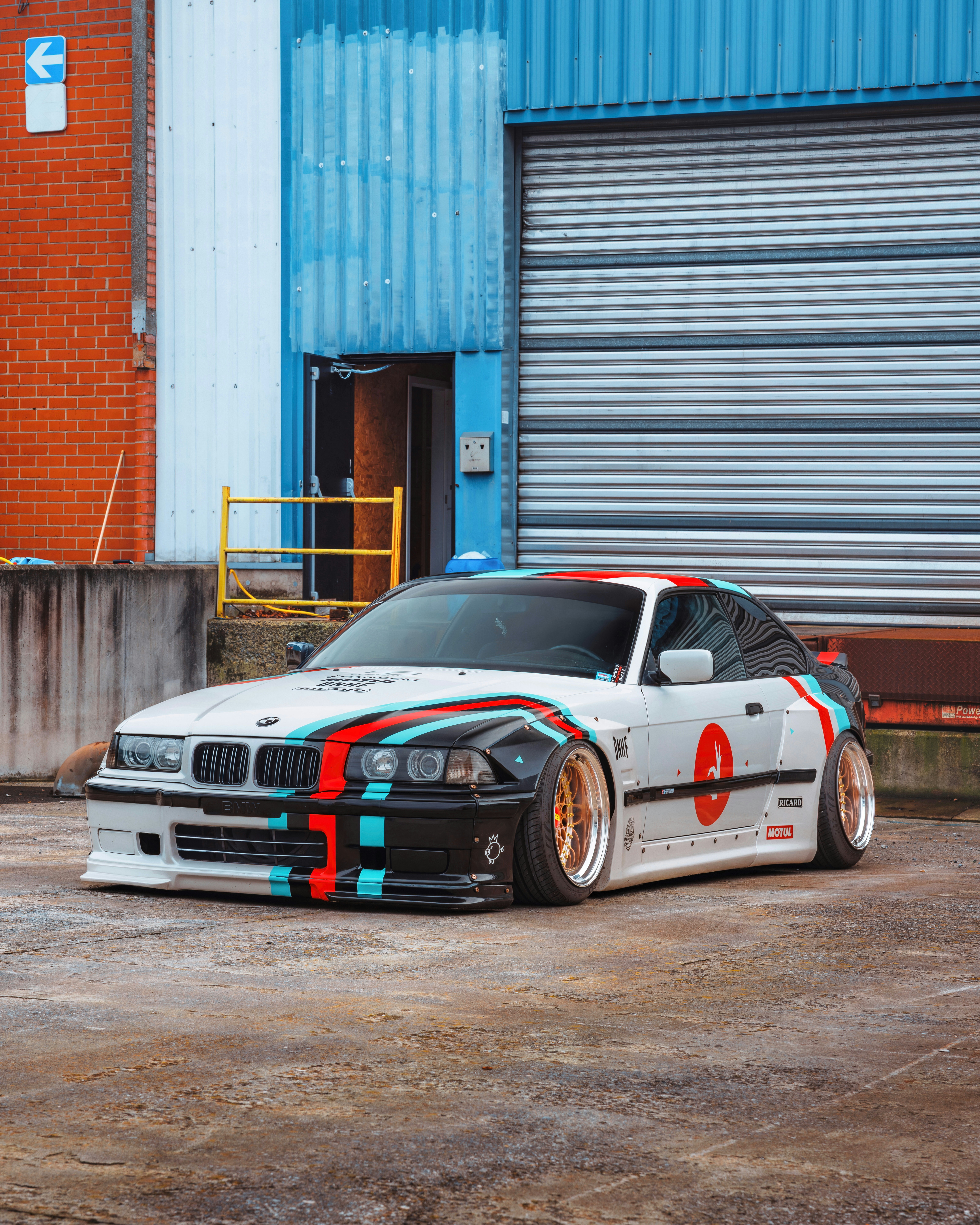 White custom BMW with racing stripes parked outside. photo – Free ...