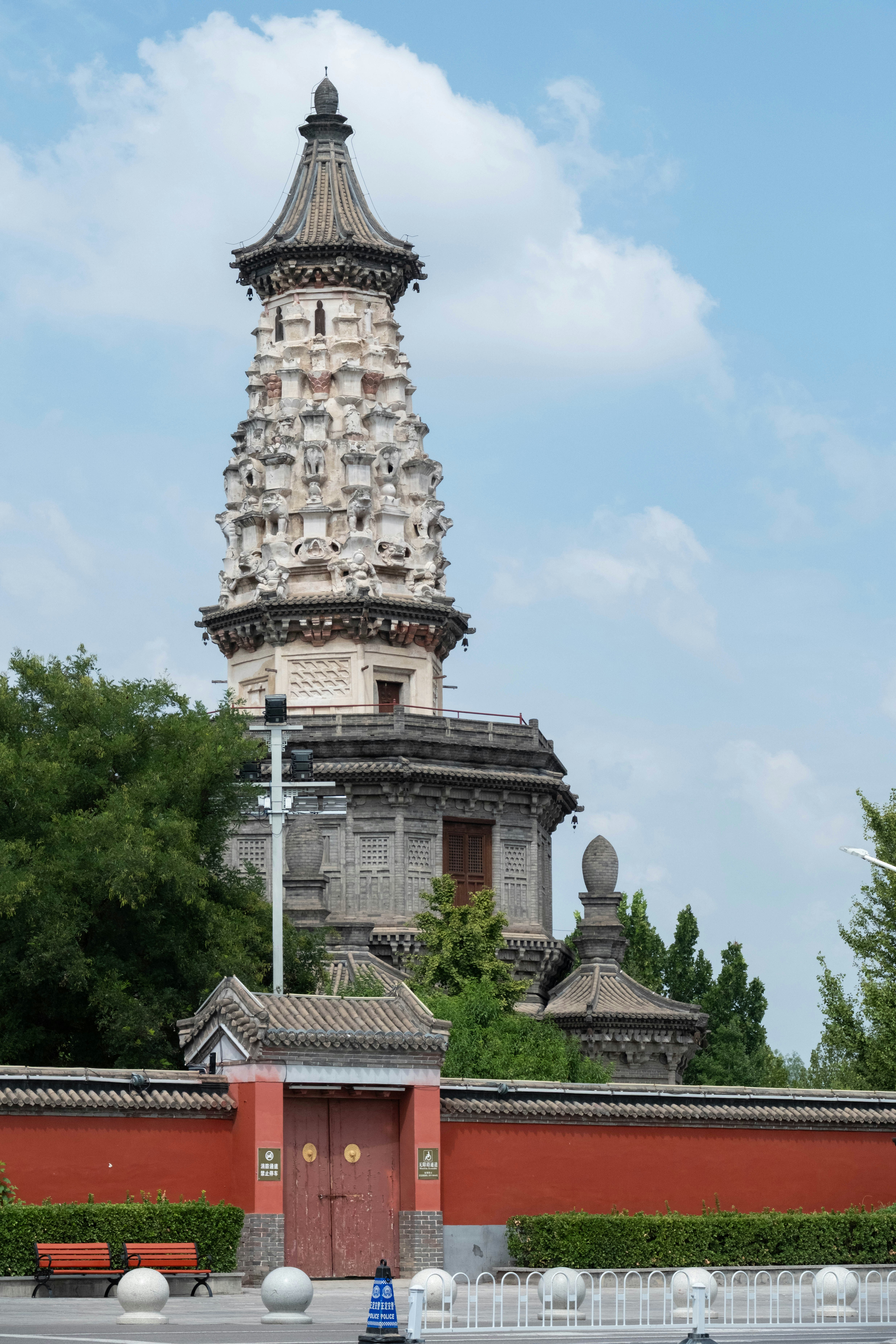 Ornate pagoda tower behind a red wall