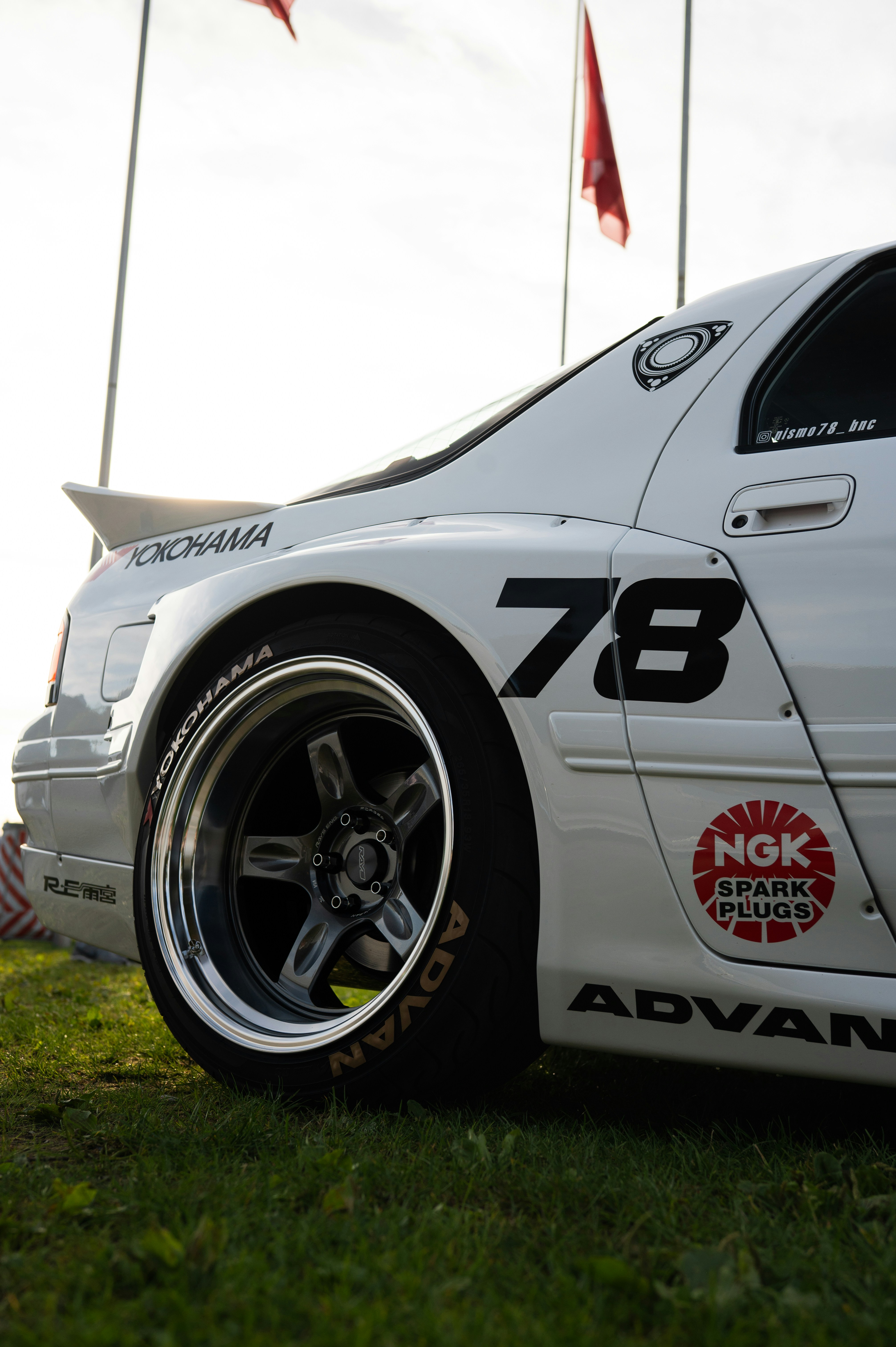 White sports car with racing decals and yokohama decals.