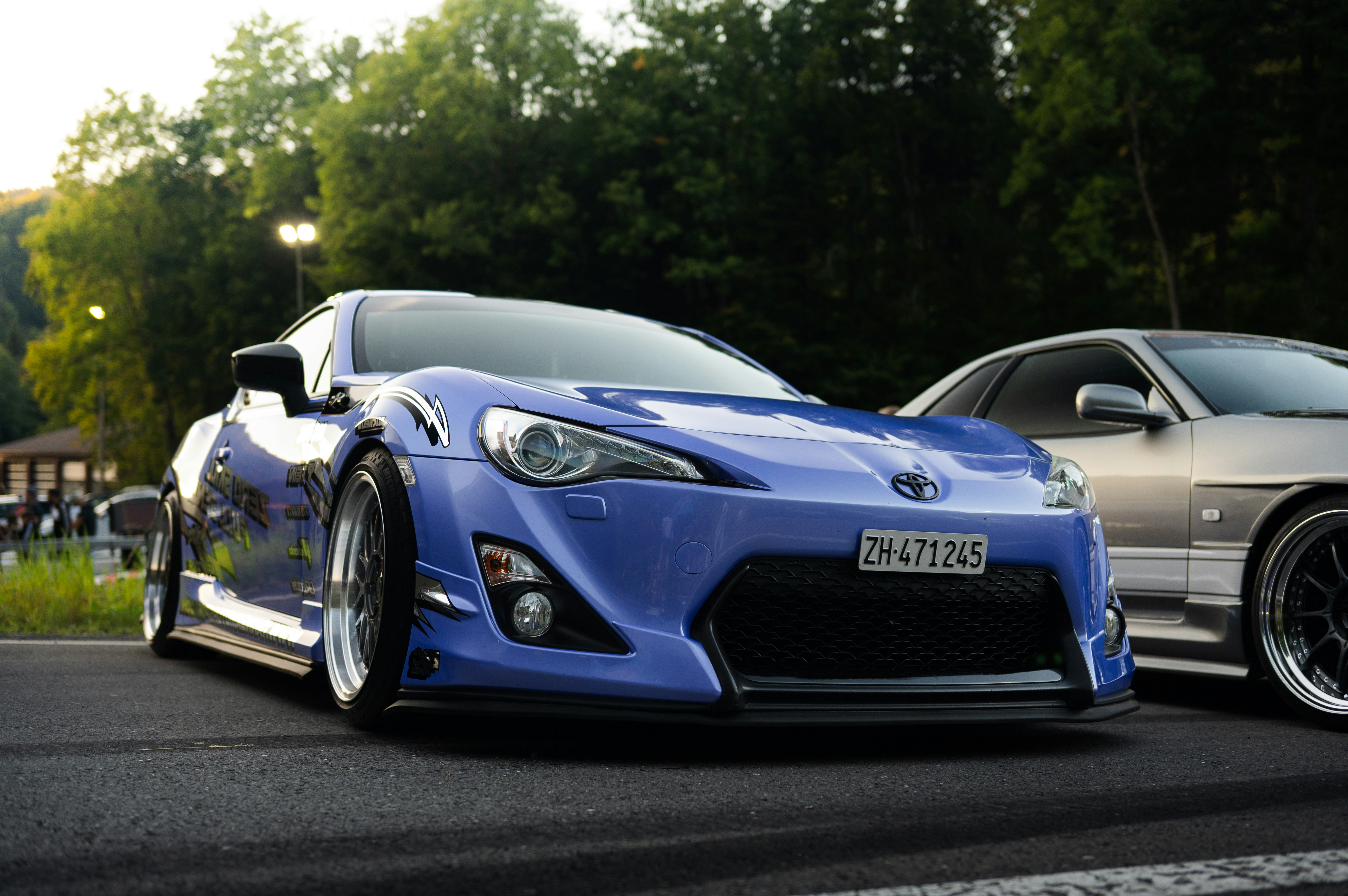 A blue sports car parked on asphalt