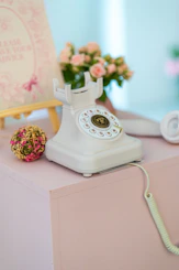Vintage white telephone with flowers and decor