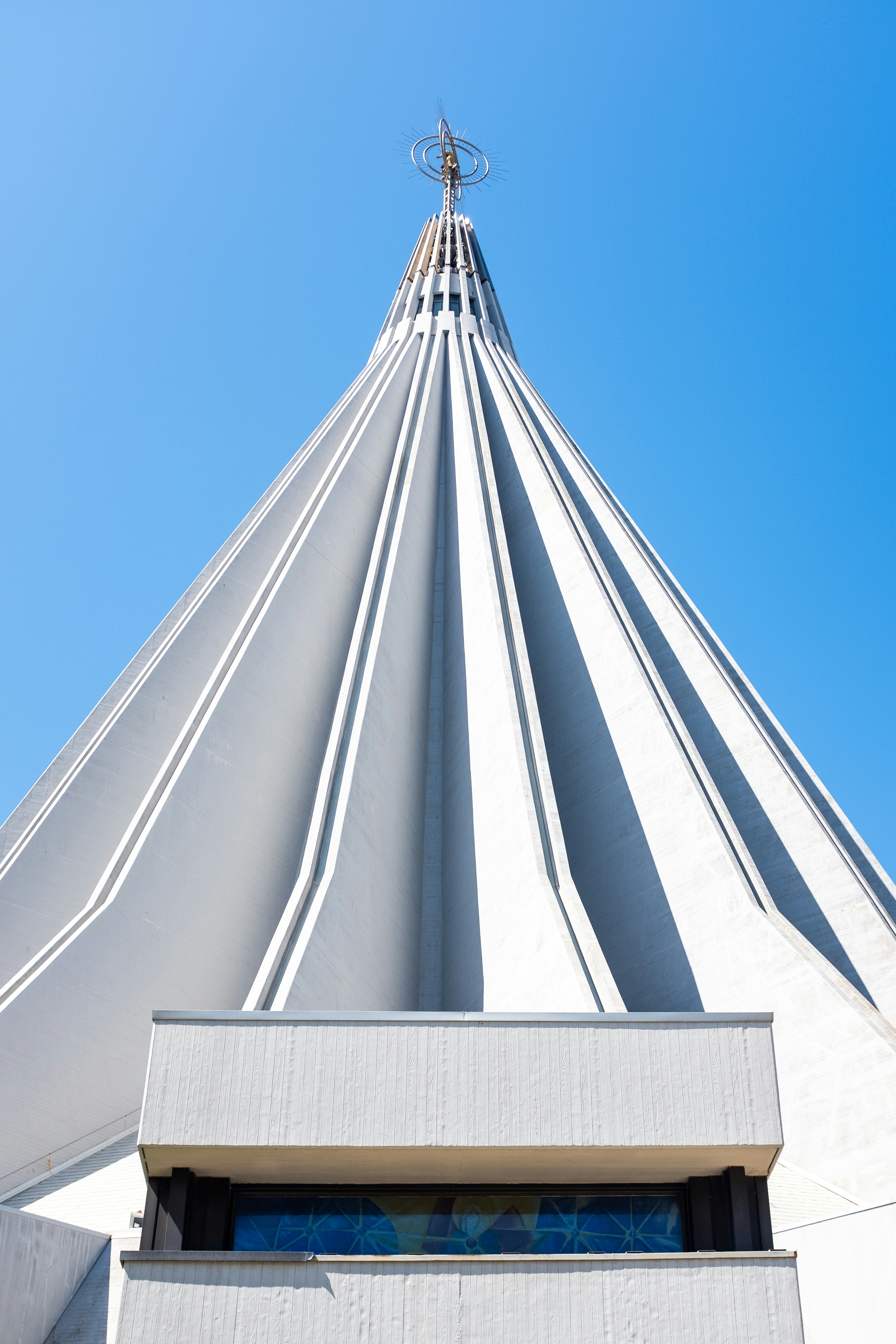 Modern church roof against a clear blue sky