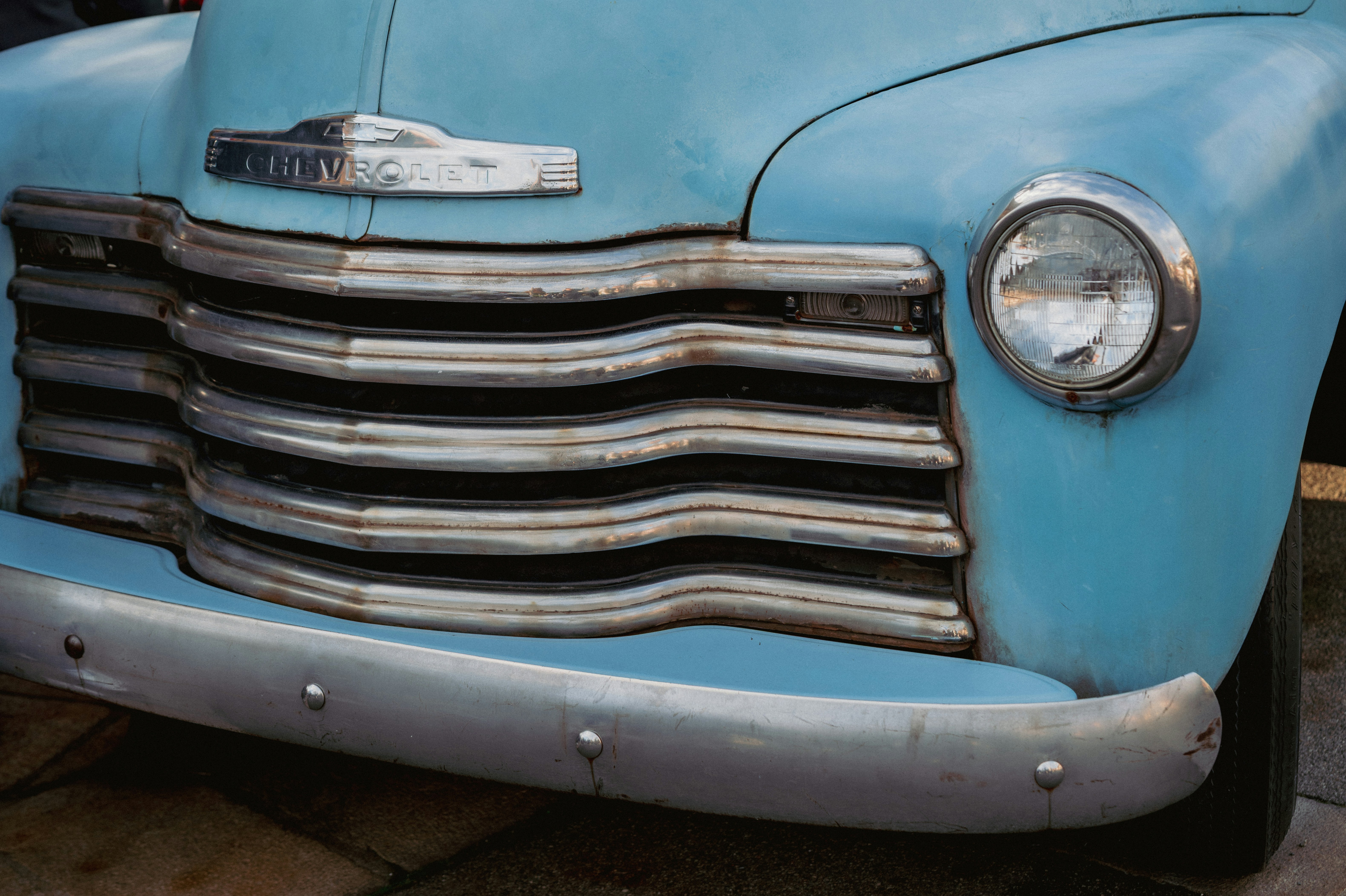 Close-up of a vintage light blue truck grille