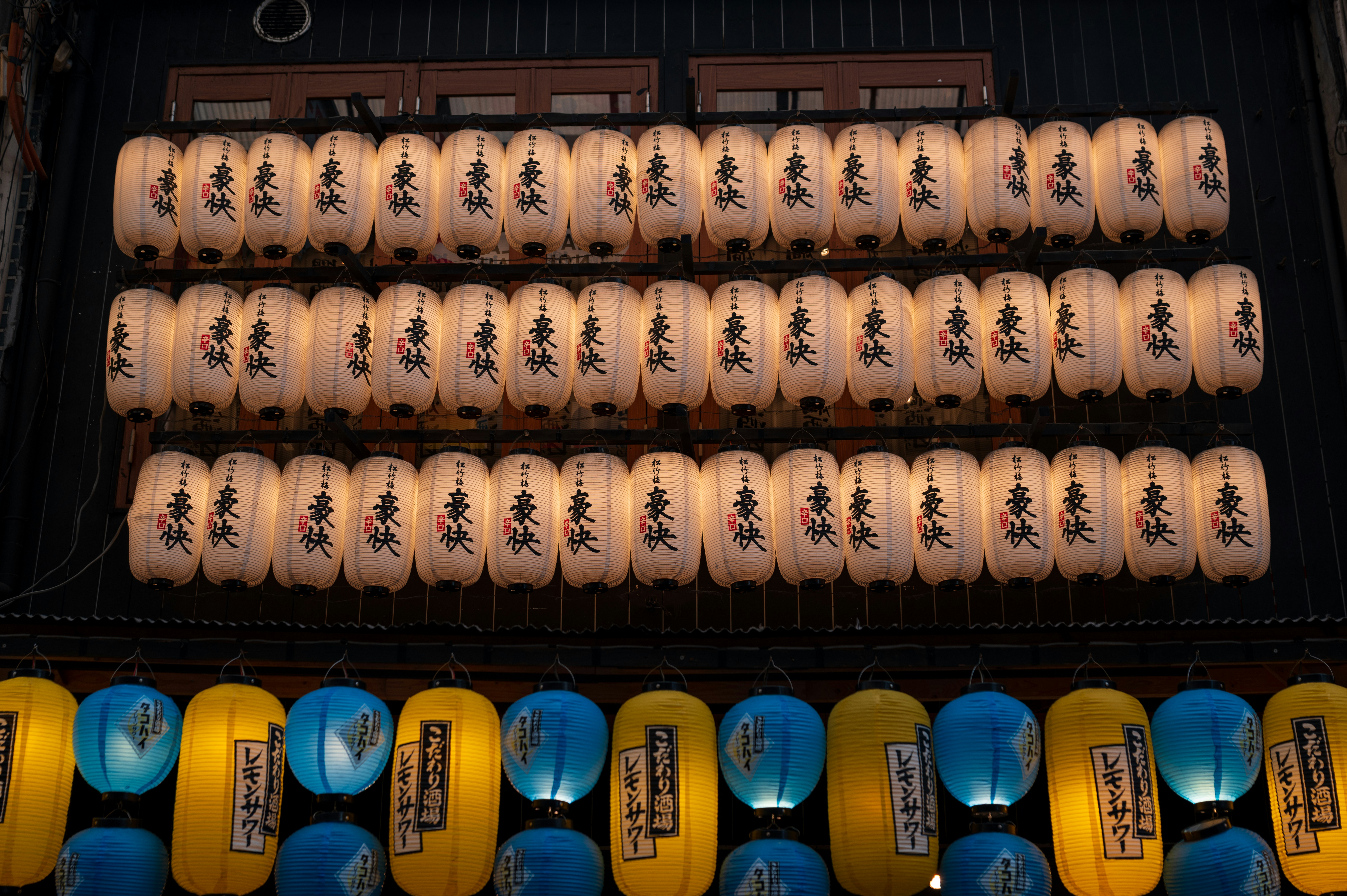 Rows of illuminated paper lanterns hang in rows.