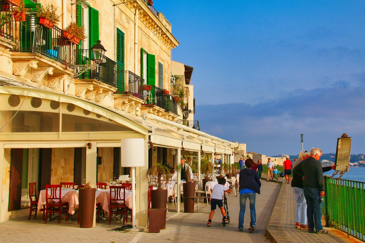 Elderly couple enjoying a European city waterfront with accessible pathways