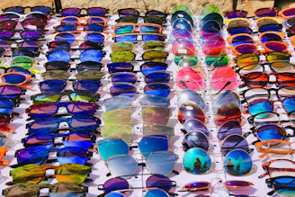 Rows of colorful sunglasses displayed for sale.