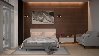 Modern bedroom with a bed, sofa, and artwork.