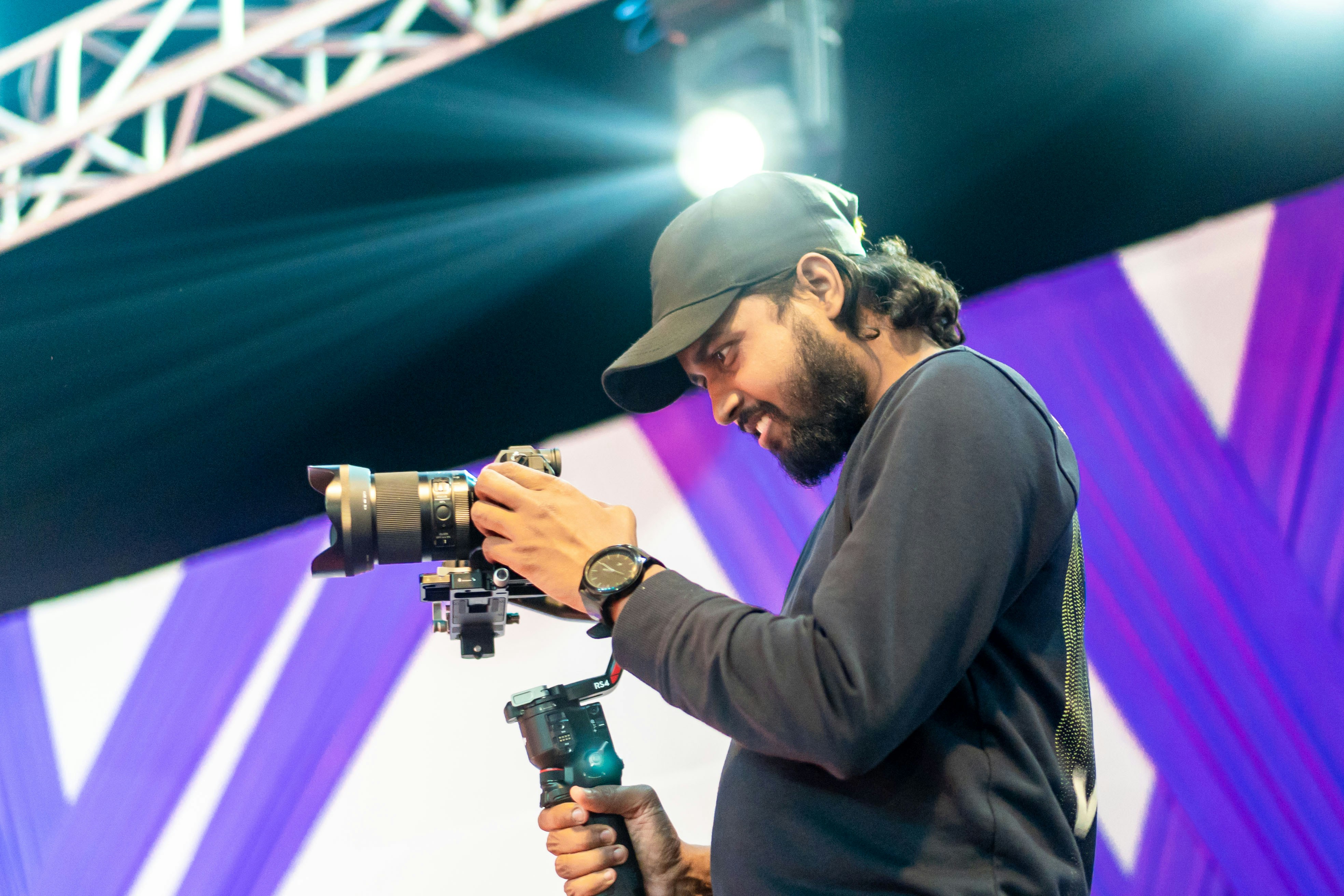 Man with beard operating a camera on a gimbal