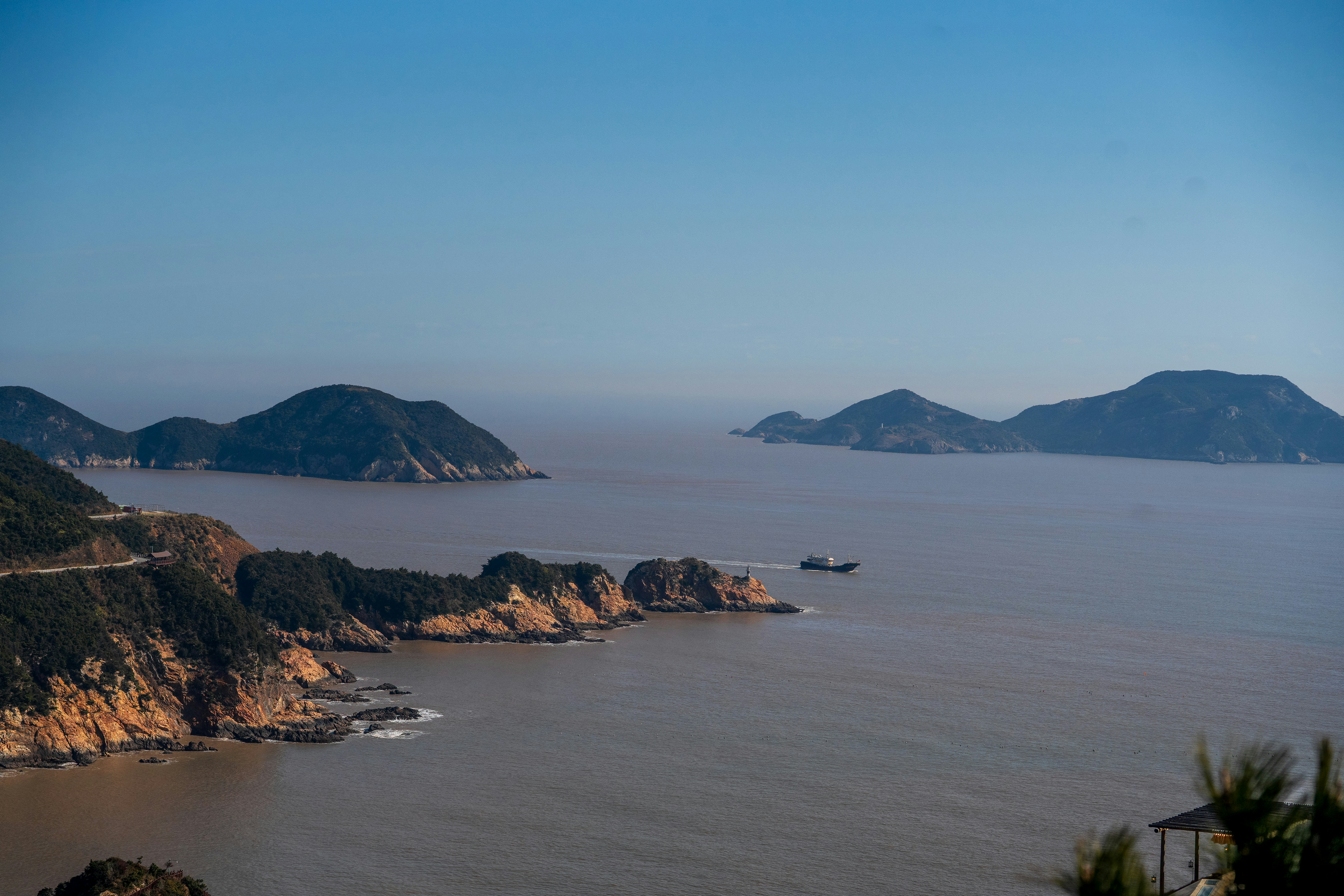 Inseln säumen den ruhigen Ozean unter klarem Himmel