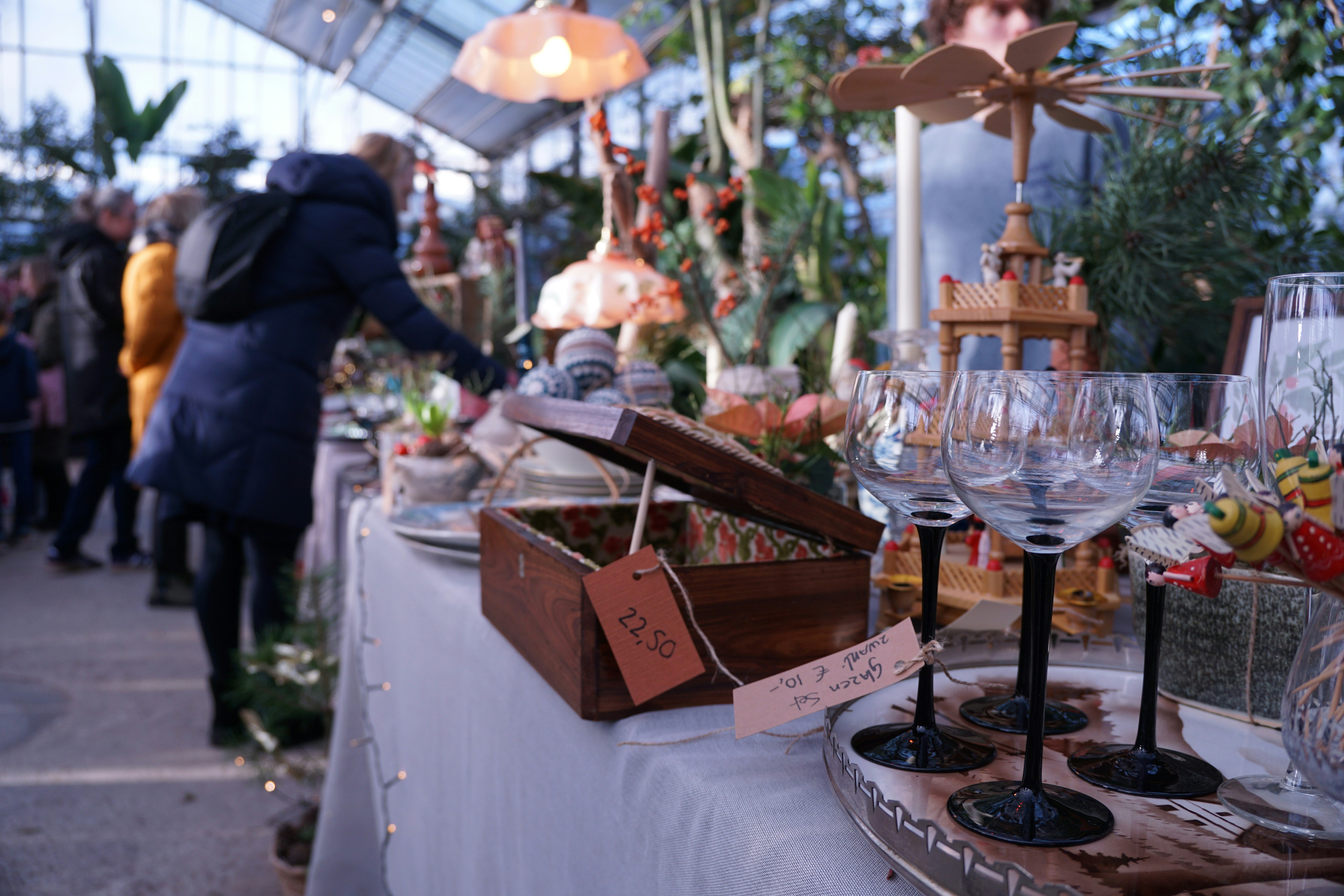 People browsing items at a market stall