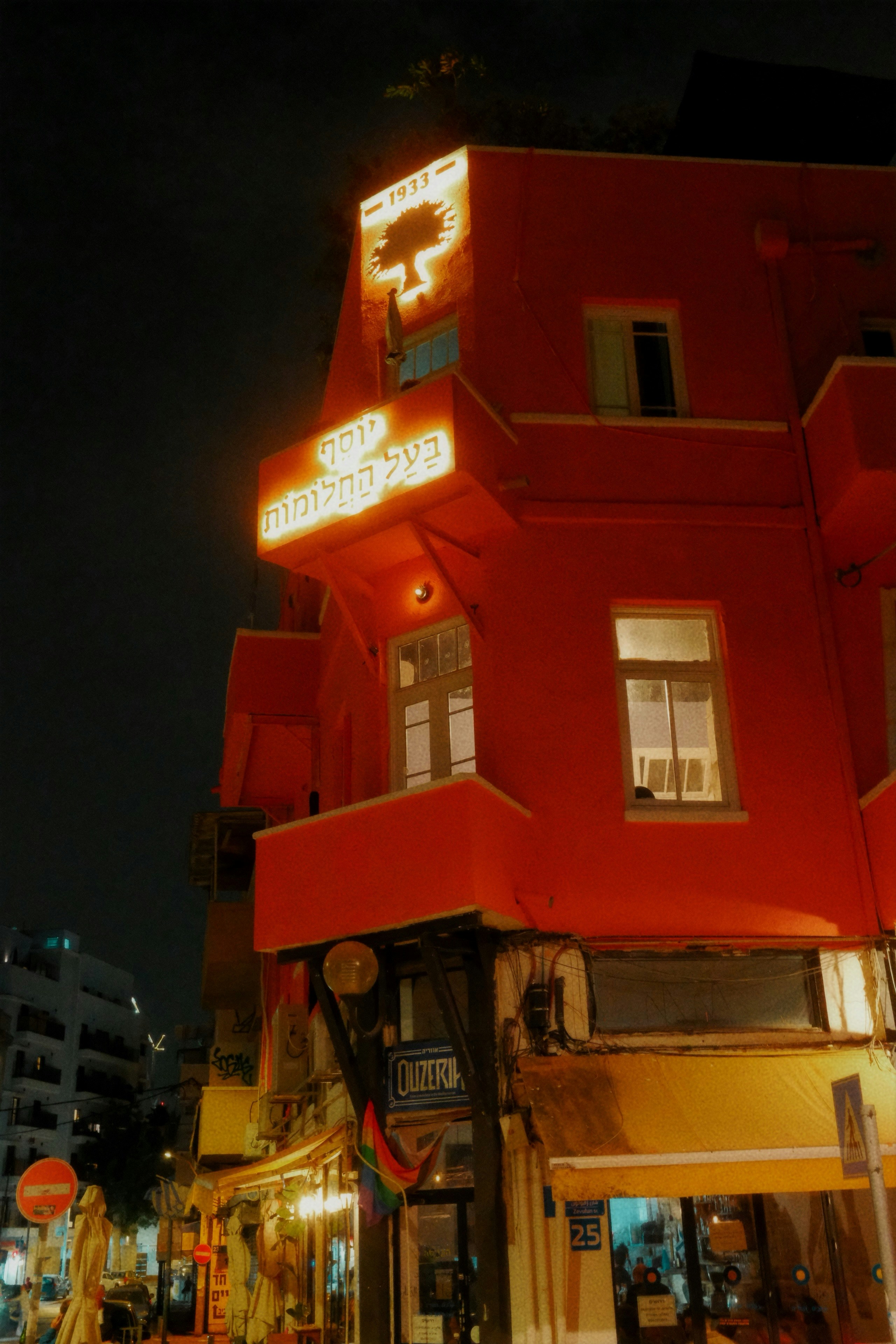 Bright red building with illuminated signs at night