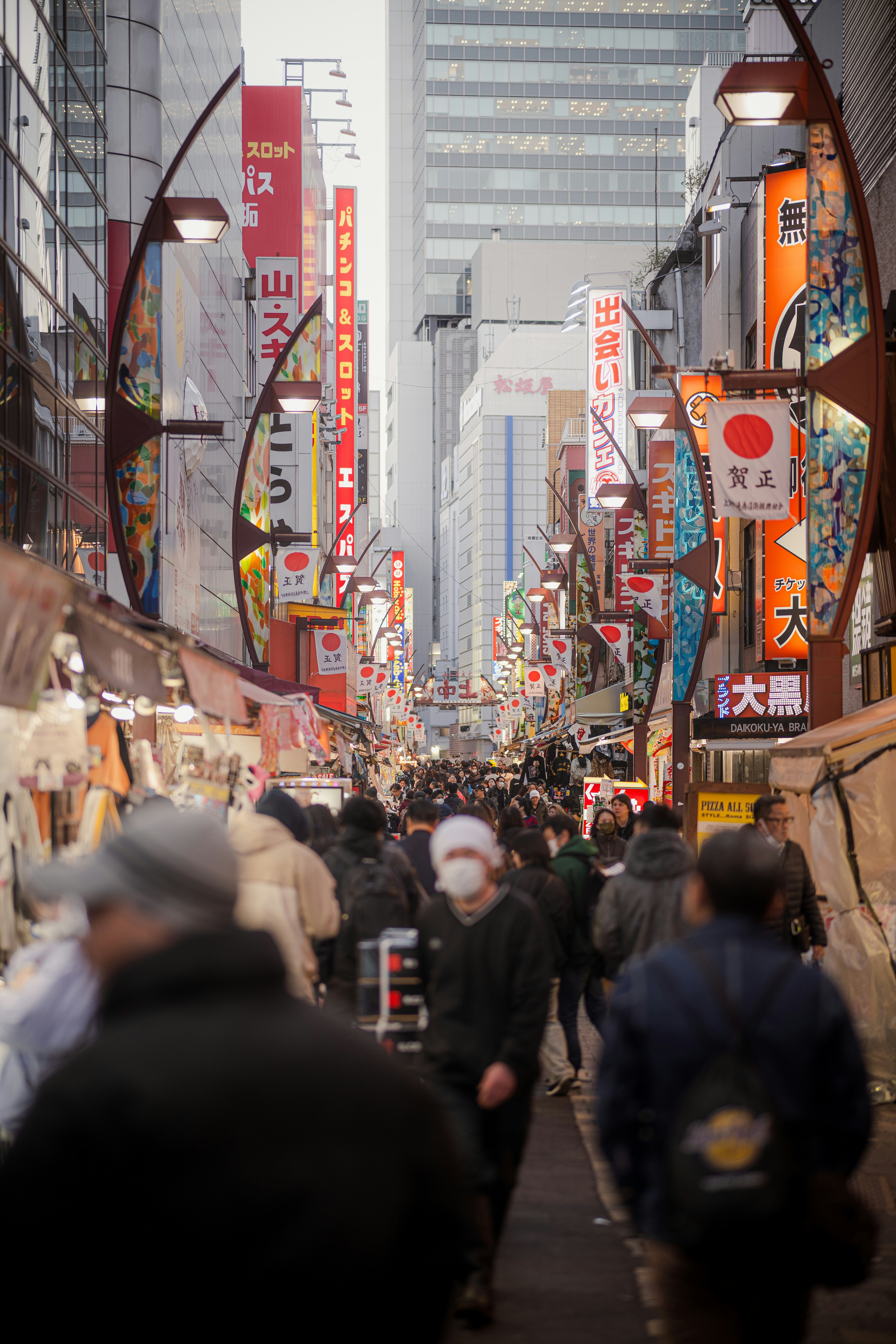 Crowded street market with japanese signs and stalls