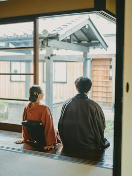 Couple in traditional japanese attire looking out window