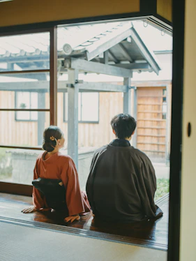 Couple in traditional japanese attire looking out window