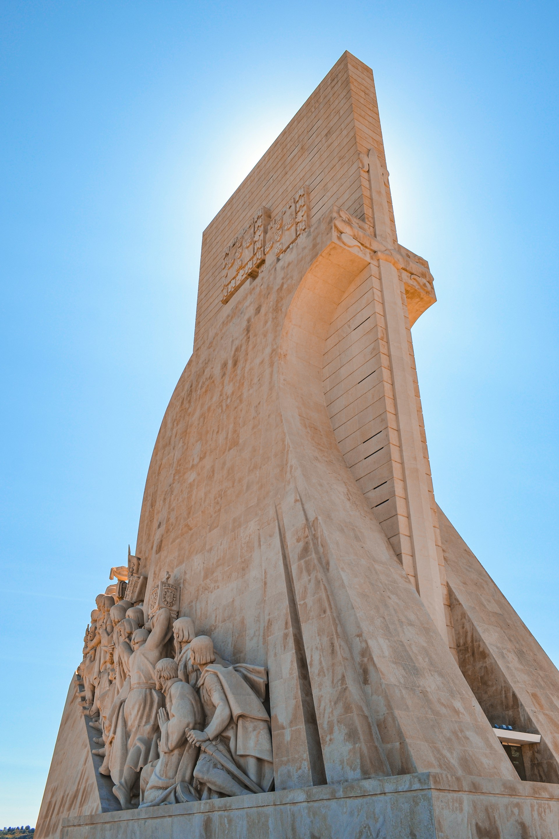 Monument with sculptures against a bright blue sky