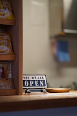 Open sign on a counter with shelves