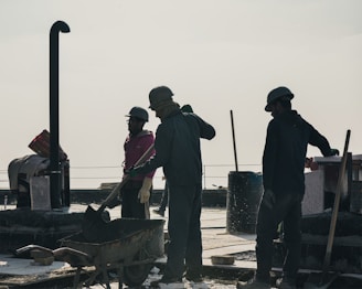 Construction workers in hard hats on a sunny day.